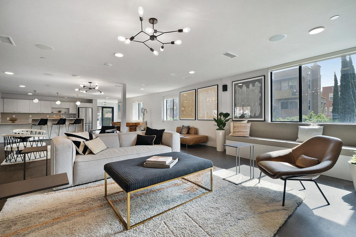 a living room filled with furniture and a large window