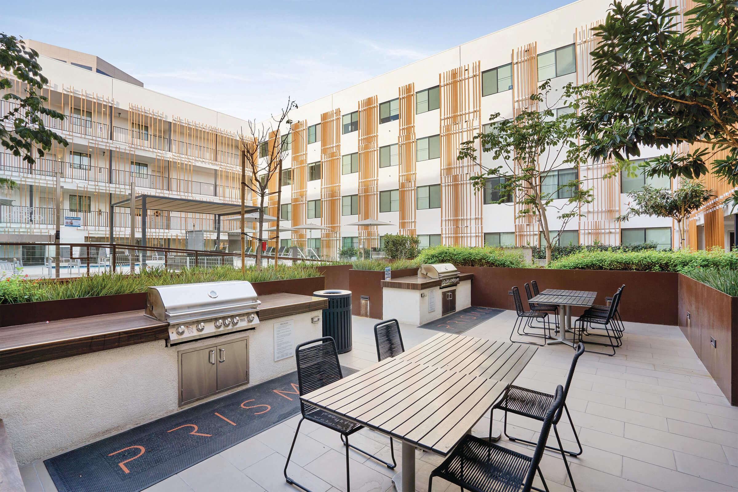 Prisma apartments has a grilling and seating area to enjoy those summer nights