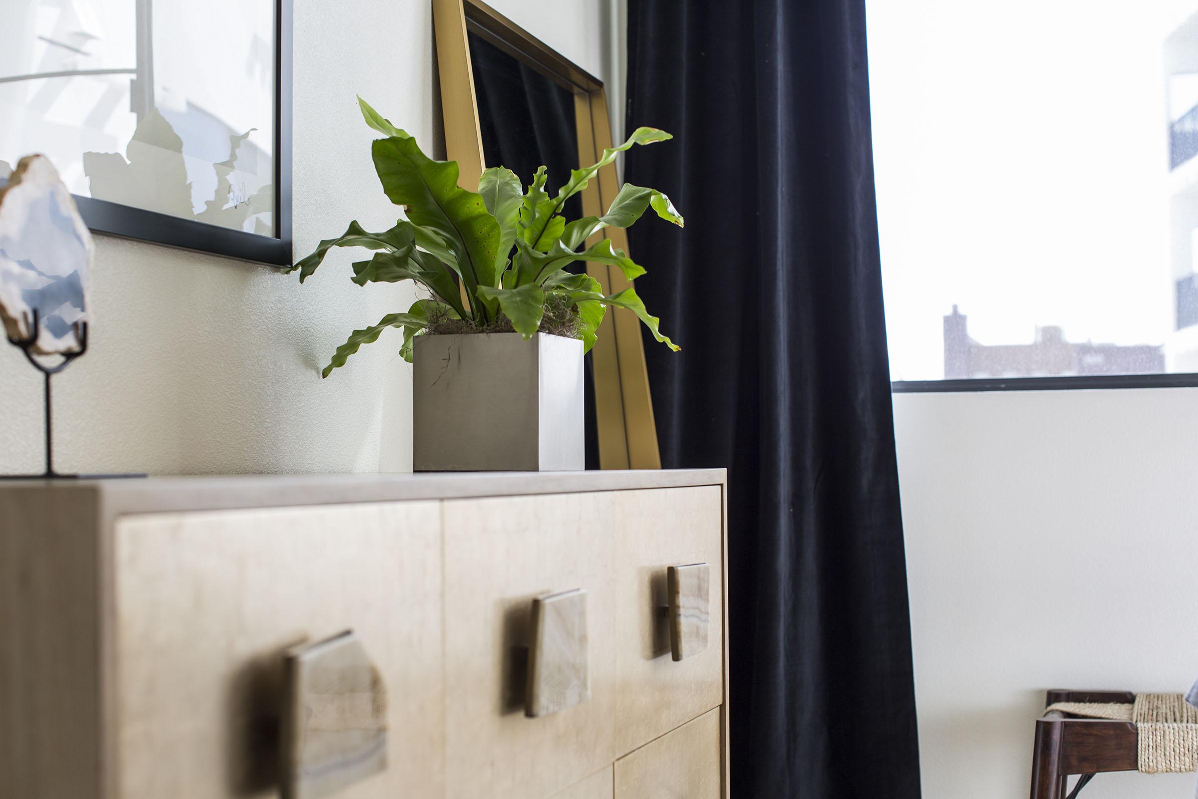 a vase of flowers next to a window