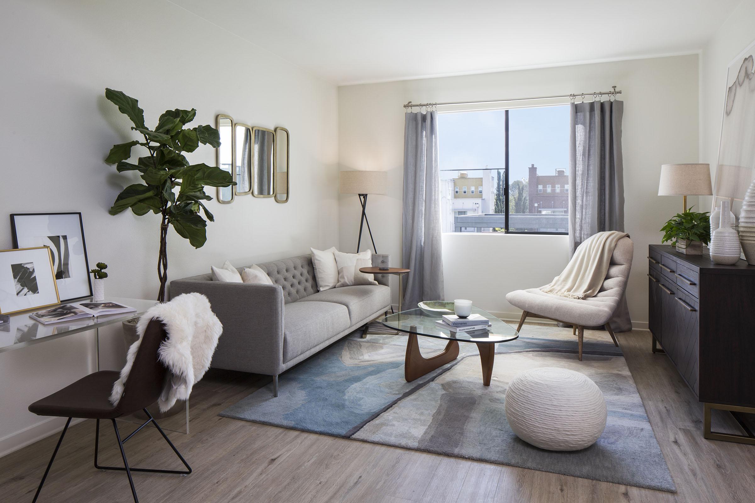 a living room filled with furniture and a large window