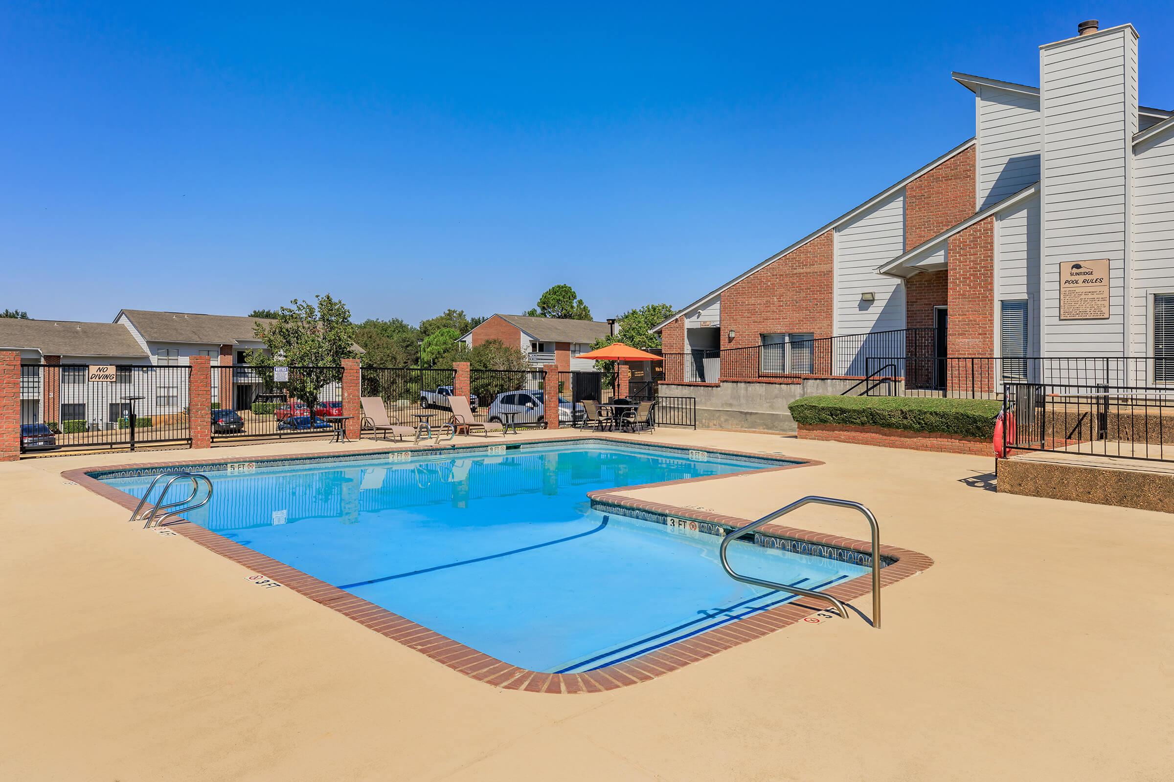 a house with a pool in front of a building