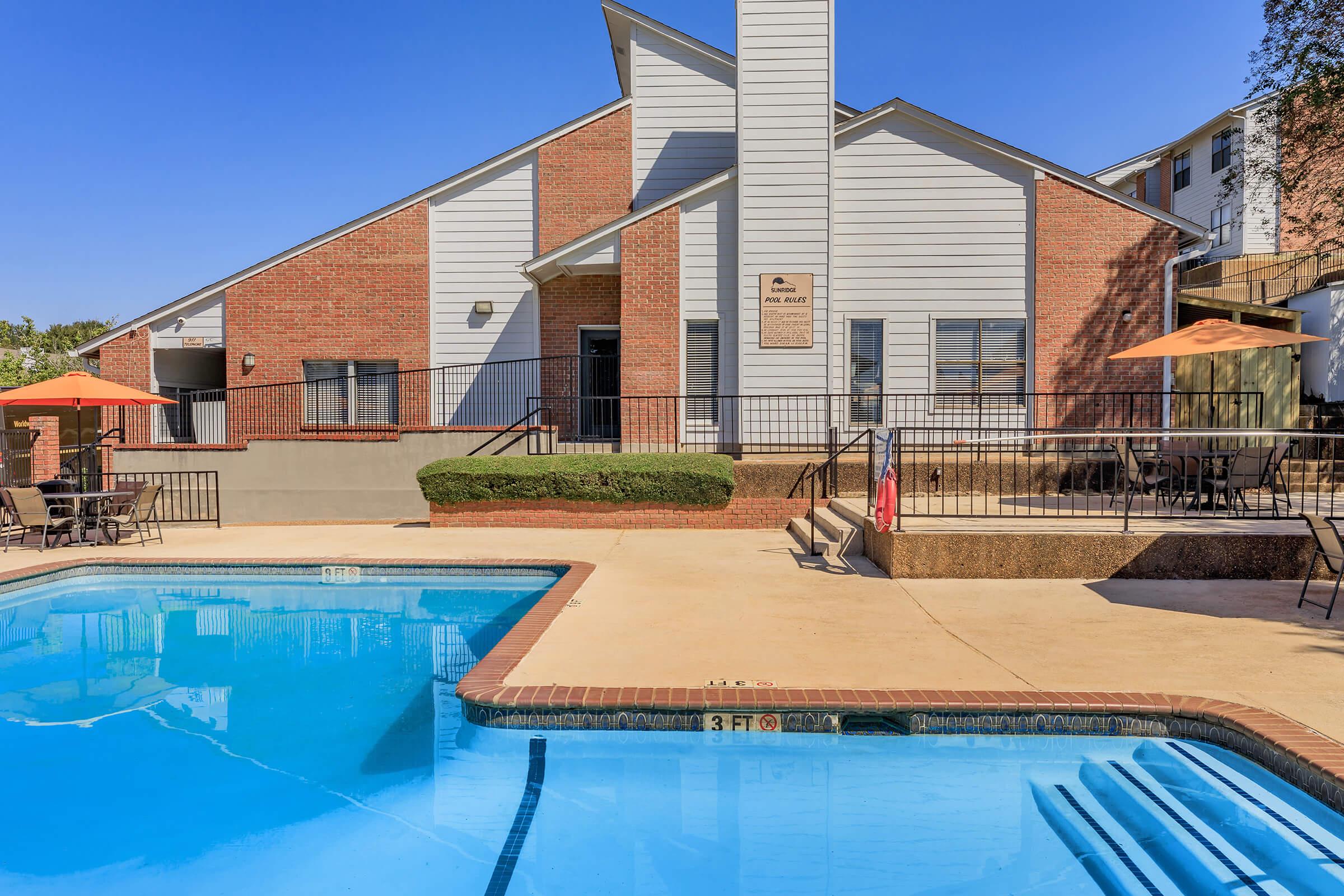 a house with a pool in front of a building