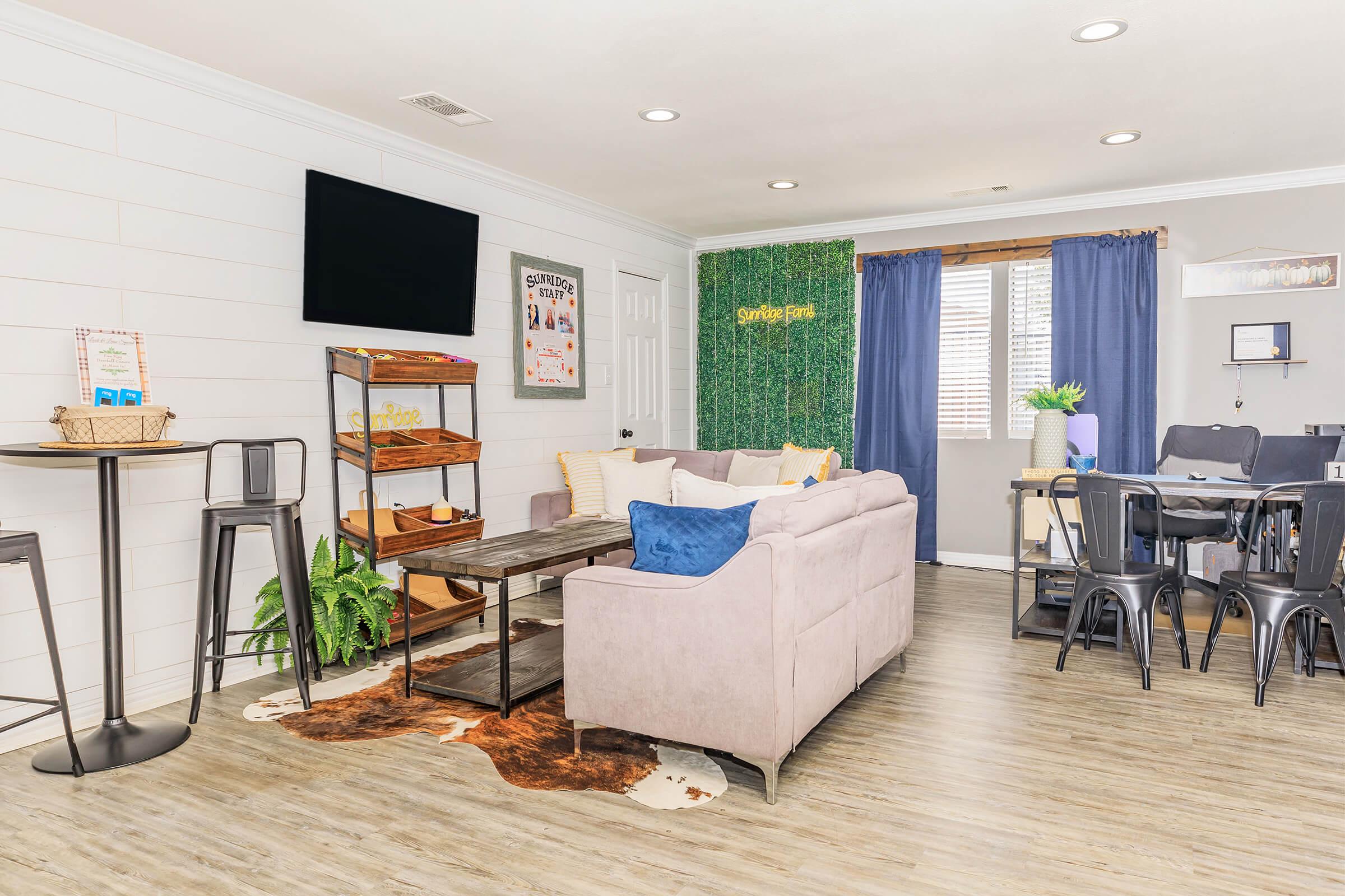 a living room filled with furniture and a large window