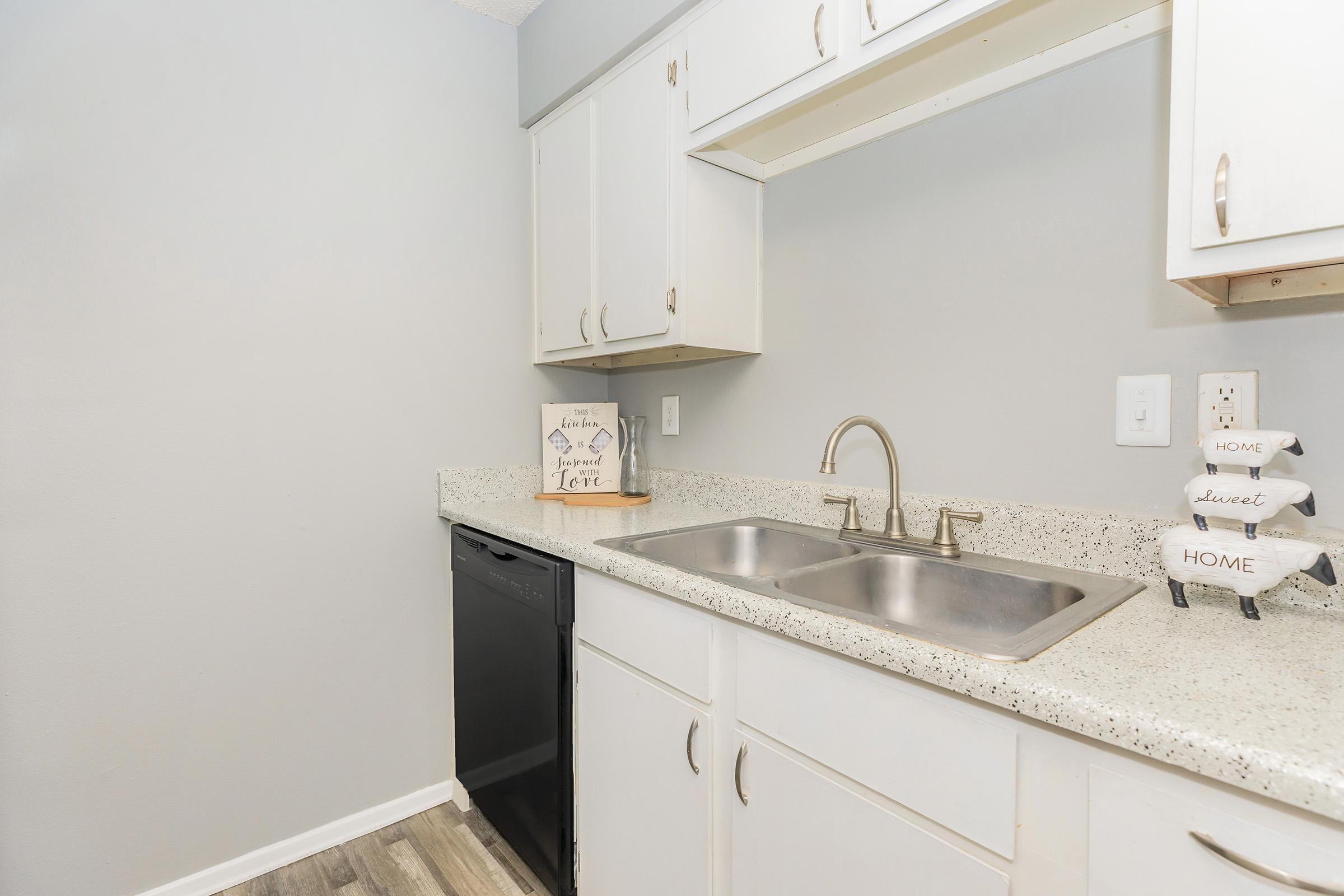 a kitchen with a sink and a mirror