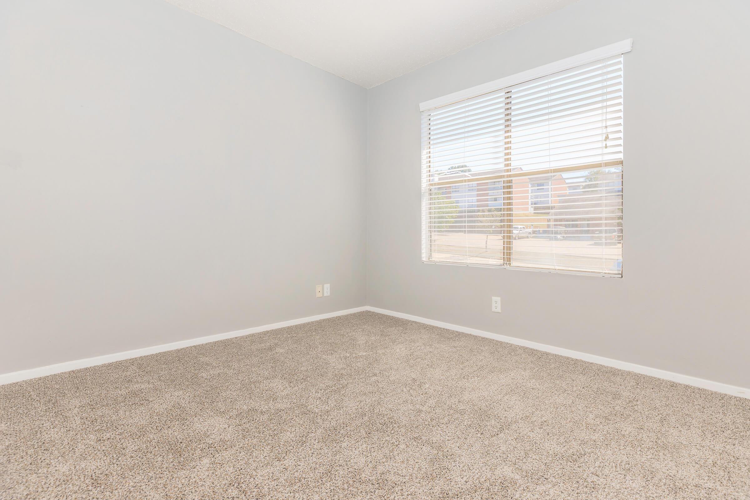 a bedroom with a large window