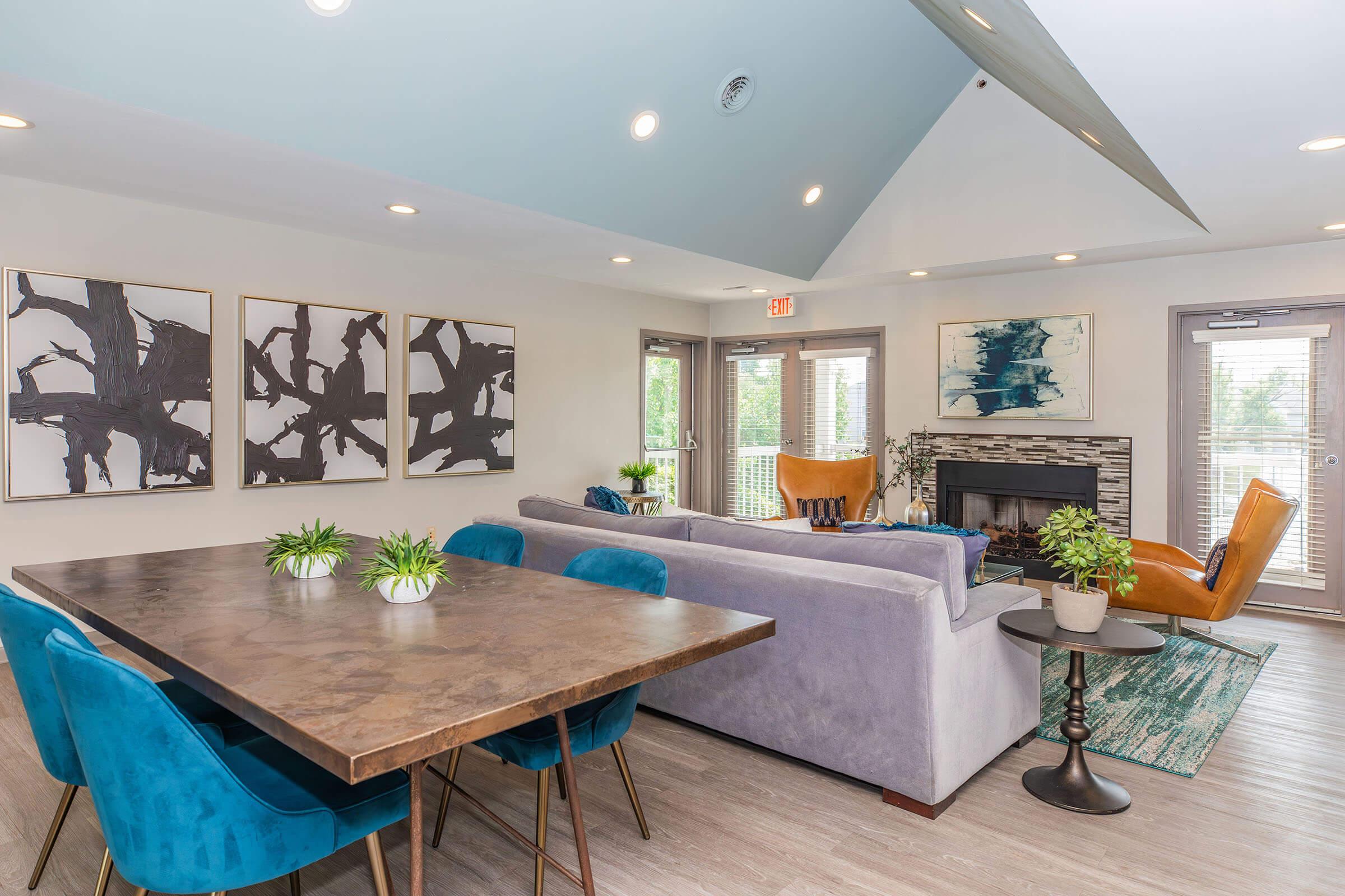 a living room filled with furniture and vase of flowers on a table