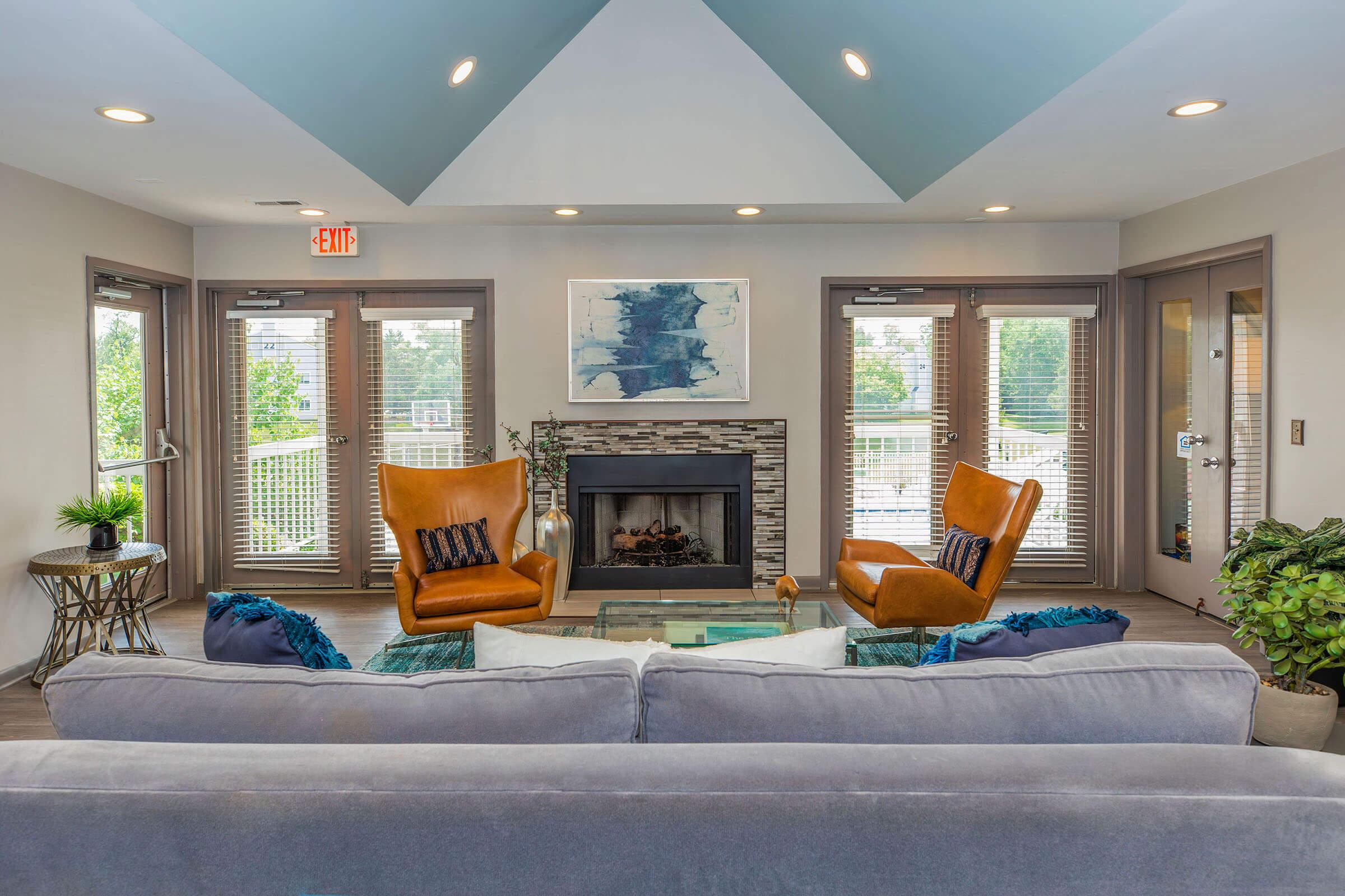 a living room filled with furniture and a large window