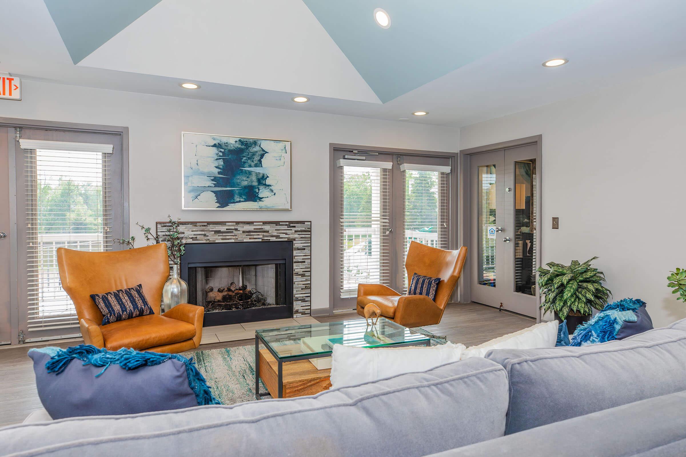 a living room filled with furniture and a large window