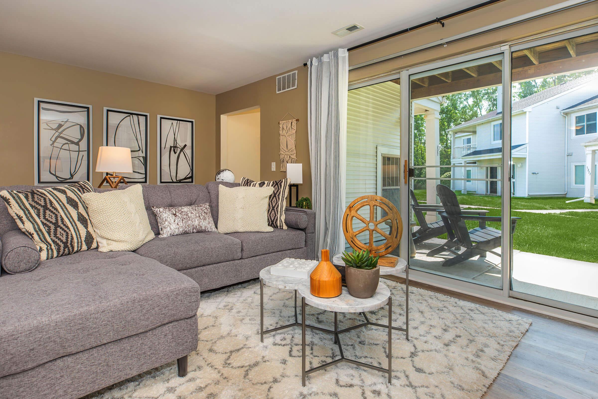 a living room filled with furniture and a large window