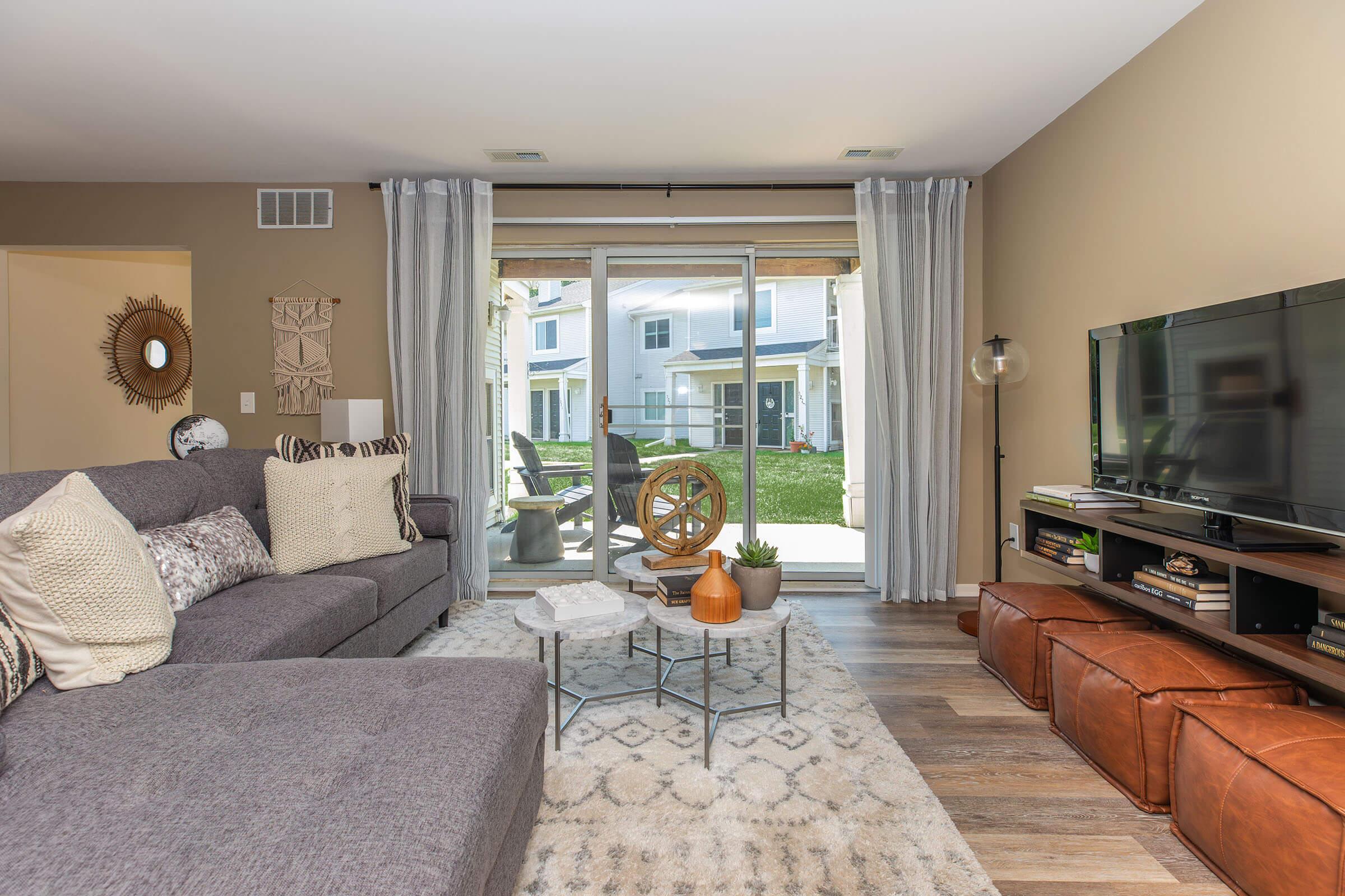 a living room filled with furniture and a flat screen tv