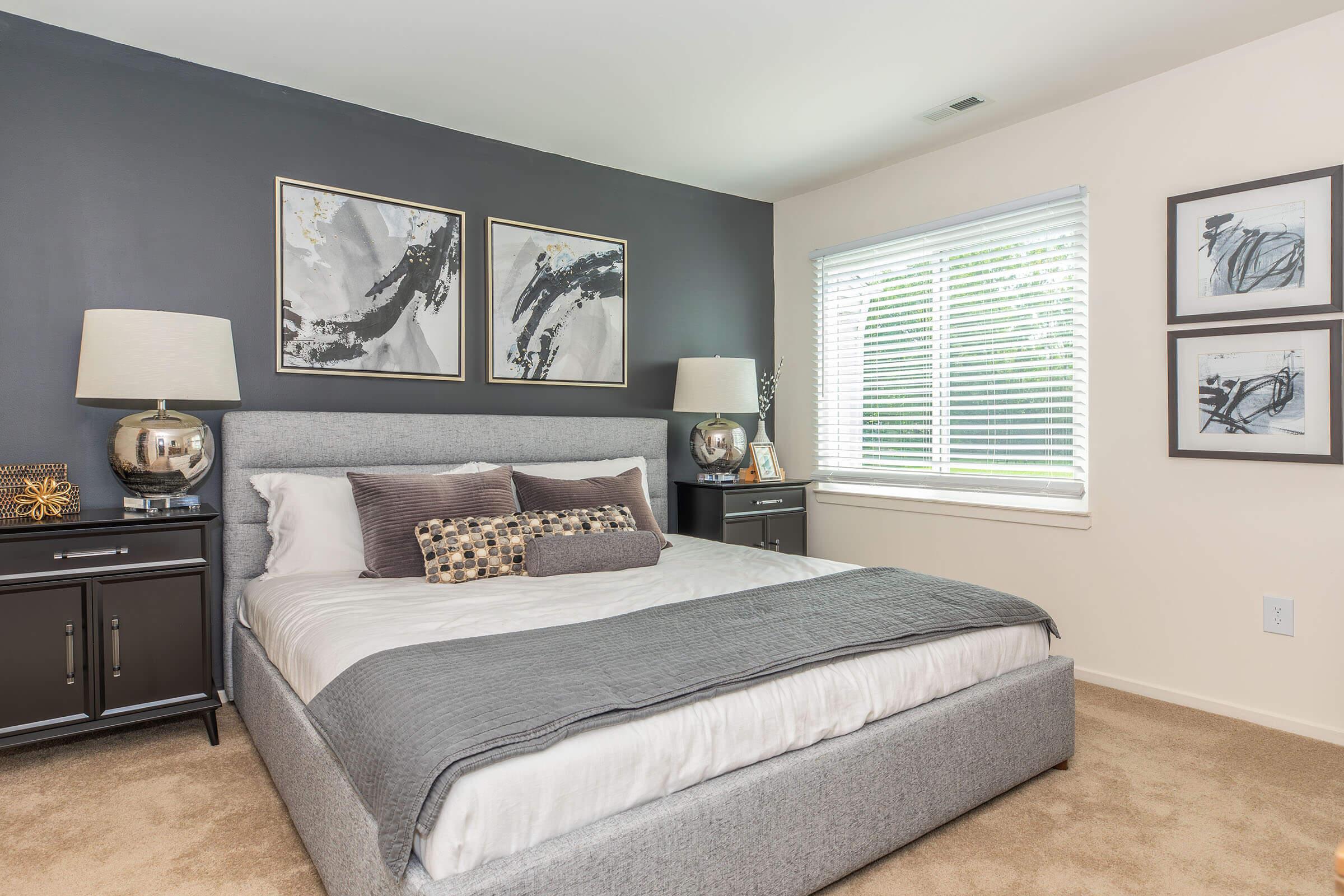 a bedroom with a bed and desk in a room