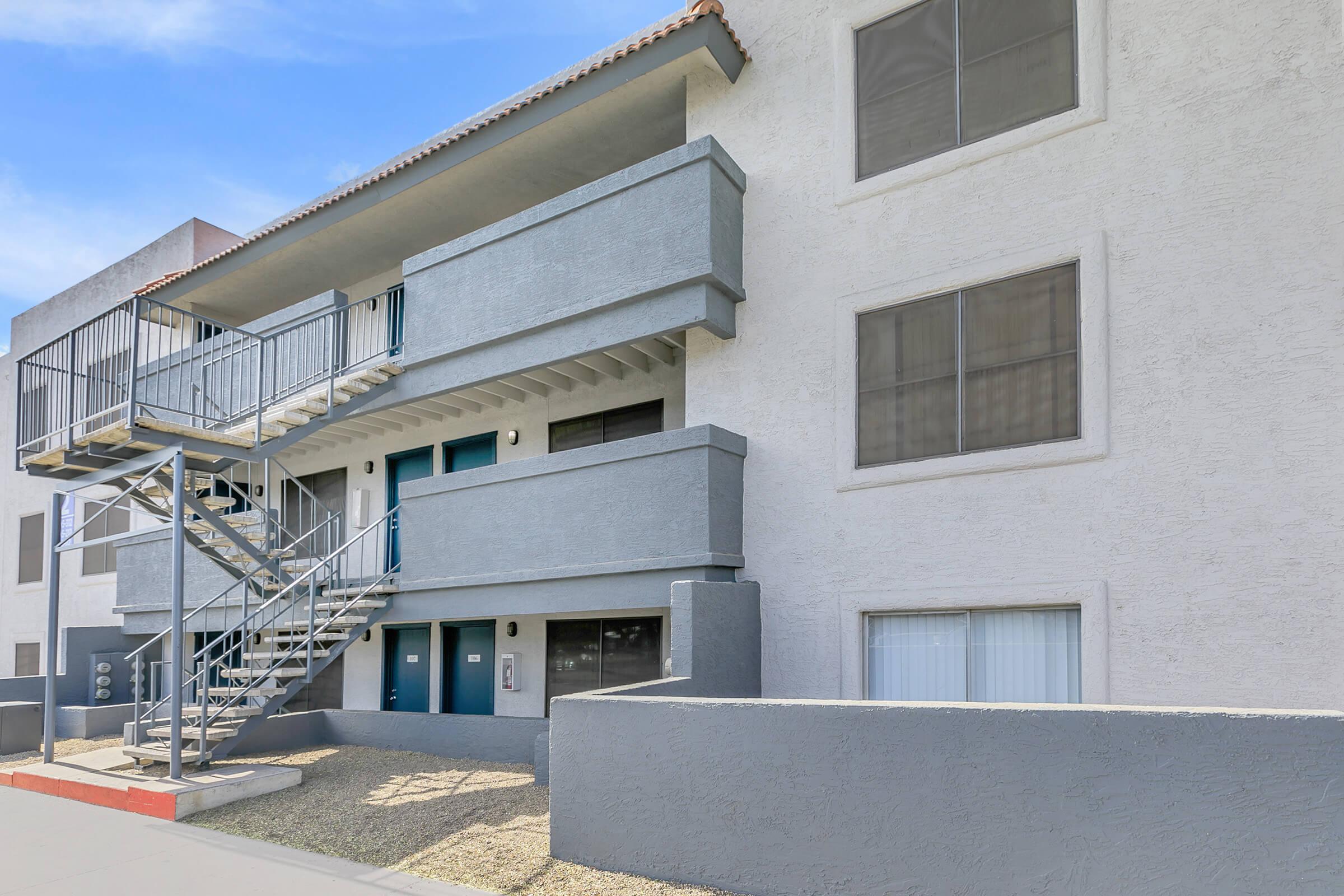 The exterior of the apartments at Rise Trailside with a patio area.