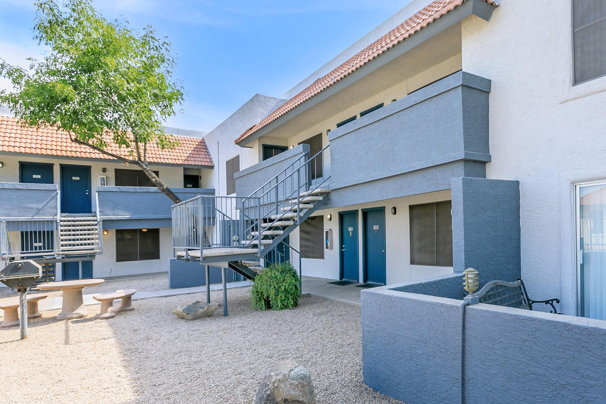 Seating area in front of the stairs to the apartments at Rise Trailside.