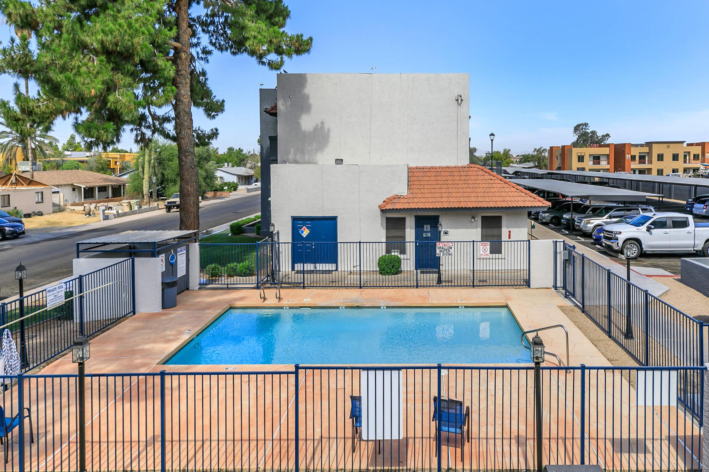 The pool area at Rise Trailside surrounded by the apartments and parking.