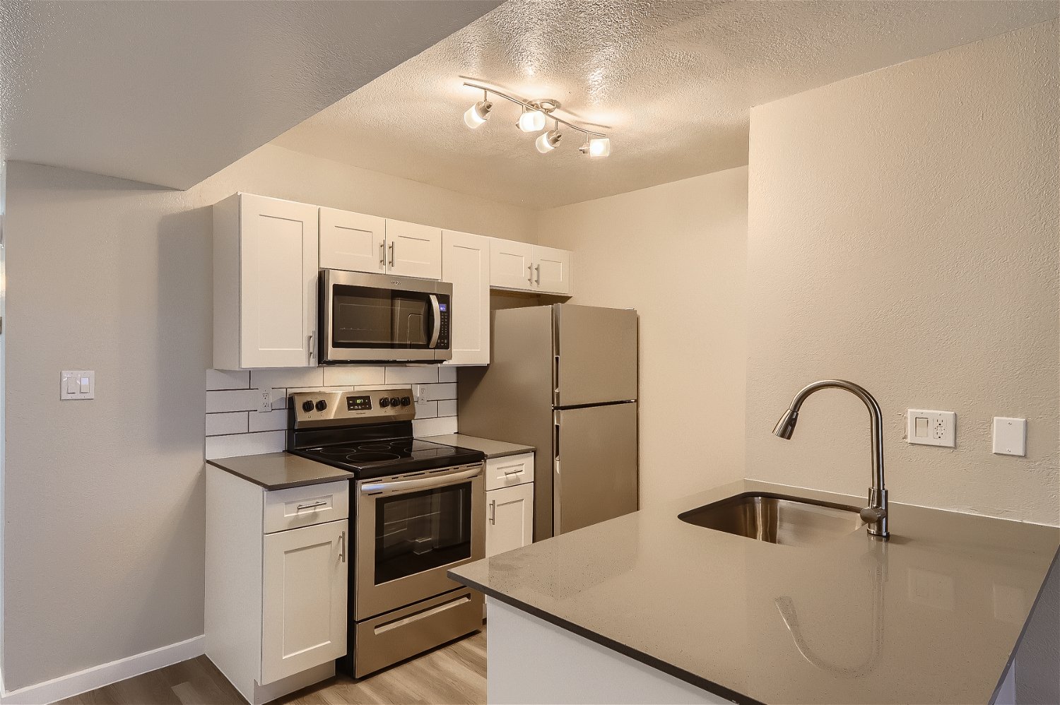 a kitchen with a sink and a refrigerator