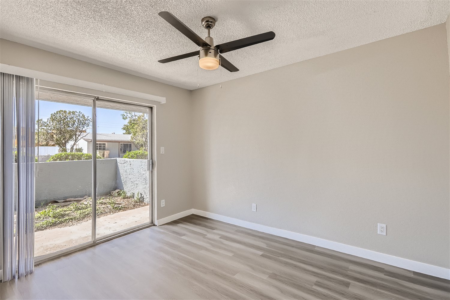 The living room with sliding glass doors at Rise Trailside.