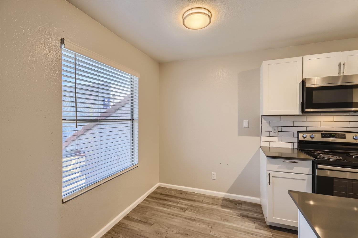 The kitchen and dining area with a window at Rise Trailside.