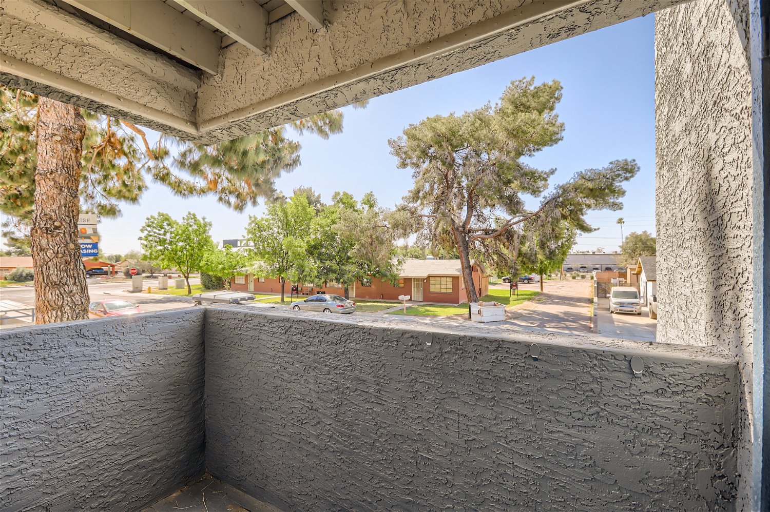 A covered balcony looking at the street at Rise Trailside. 