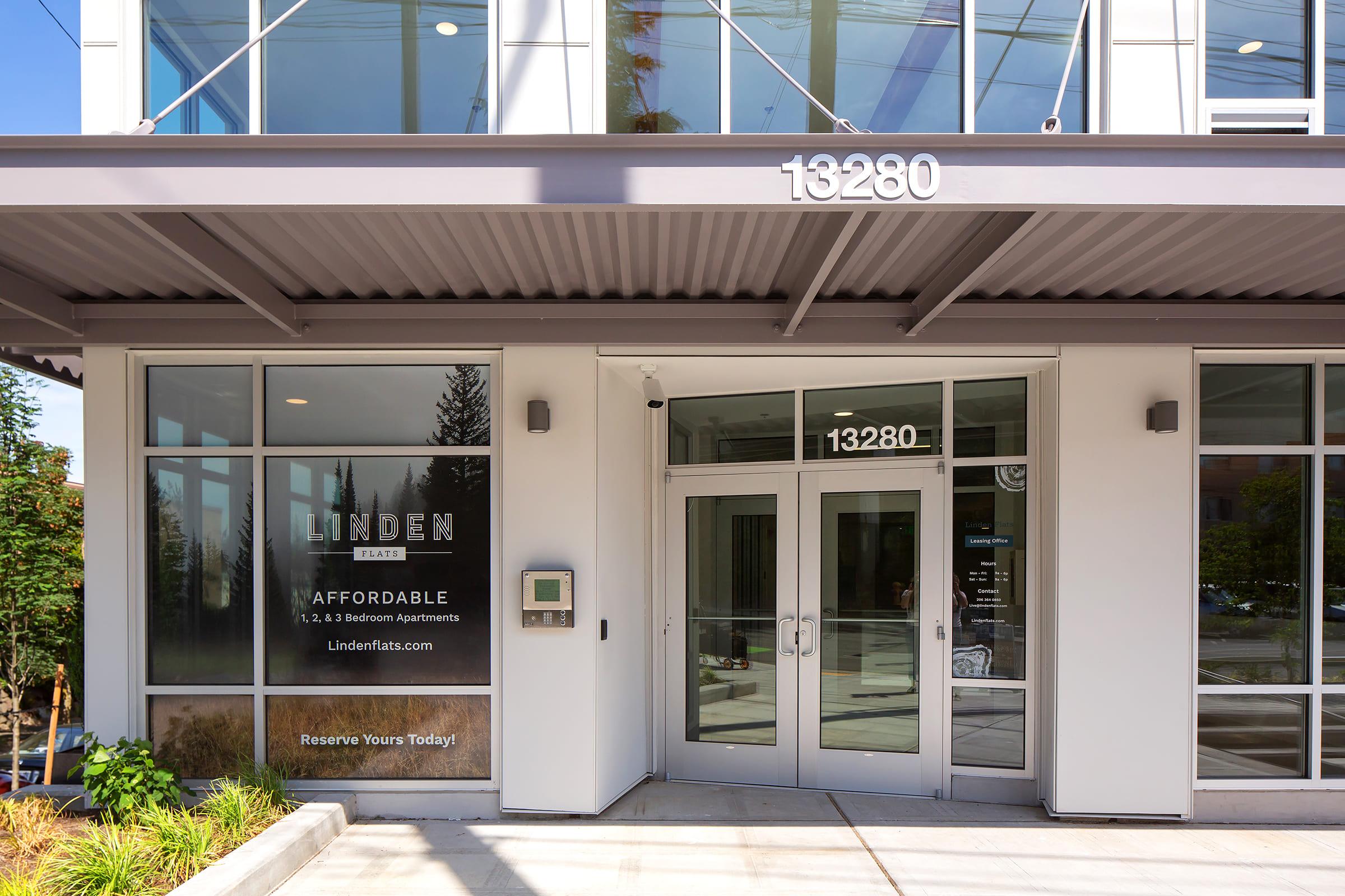 Exterior view of the Linden apartment building, showcasing the entrance with large glass windows and modern architecture. The address "13280" is prominently displayed above the door, and a sign advertises affordable 1, 2, and 3-bedroom apartments. A call-to-action encourages reservations.