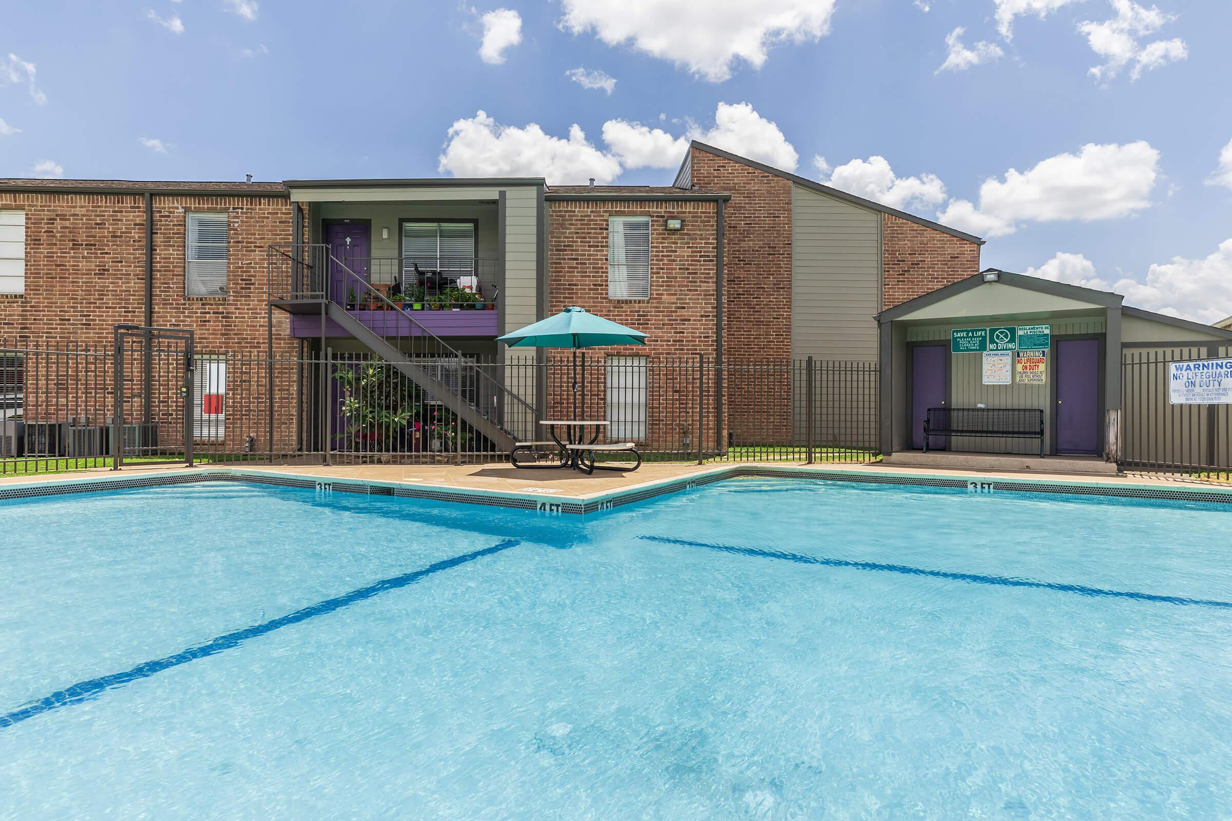 a man in a pool of water in front of a house