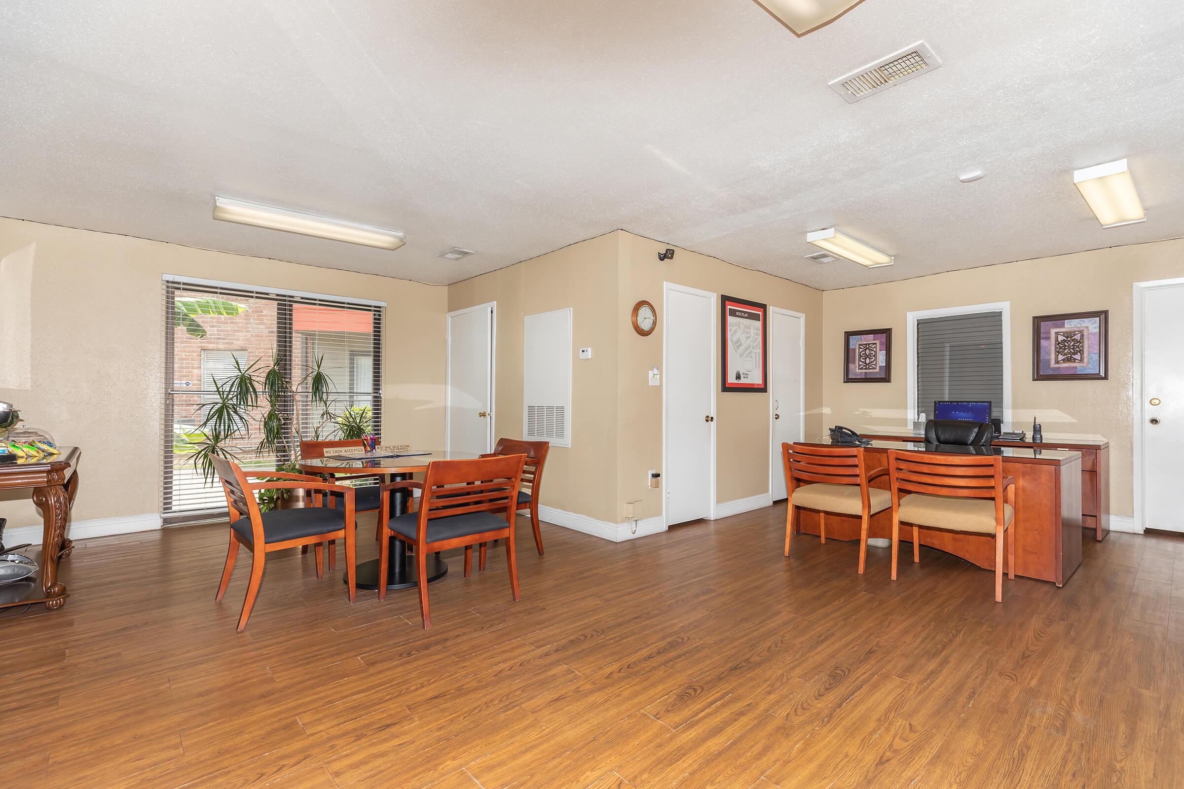 a living room filled with furniture on top of a wooden floor