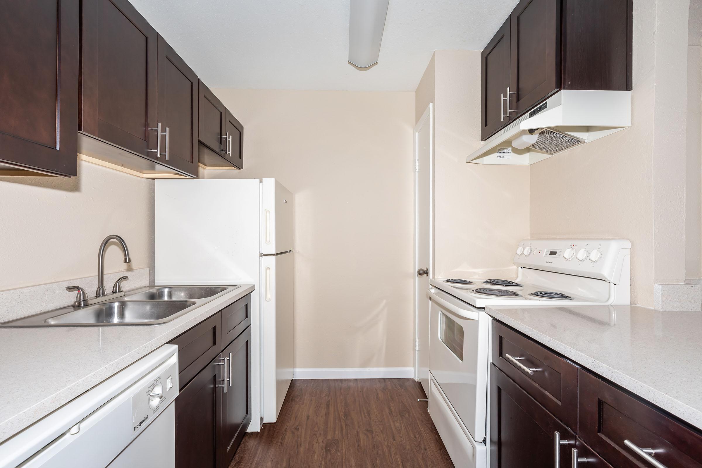 a kitchen with a stove sink and refrigerator