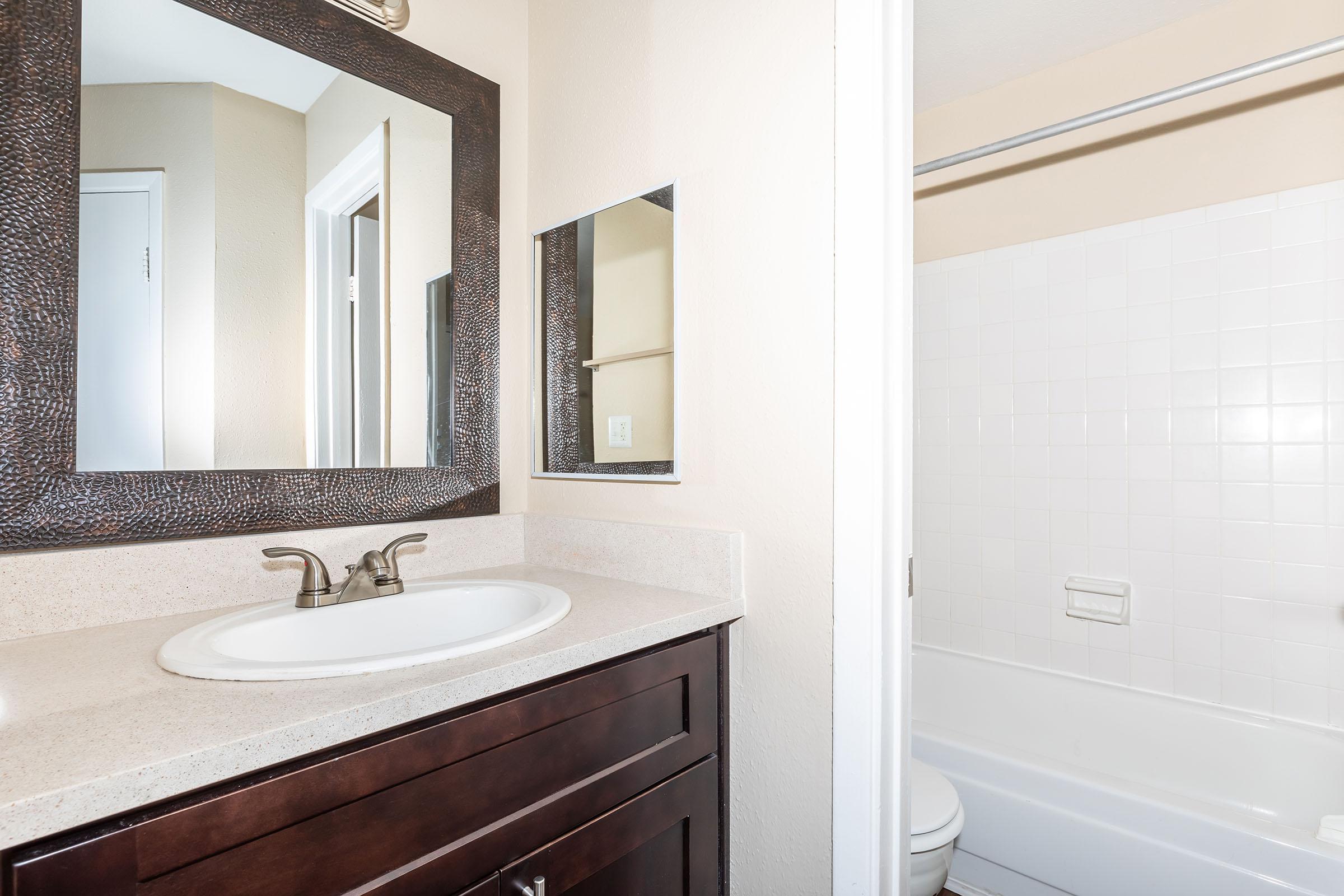 a room with a sink and a mirror