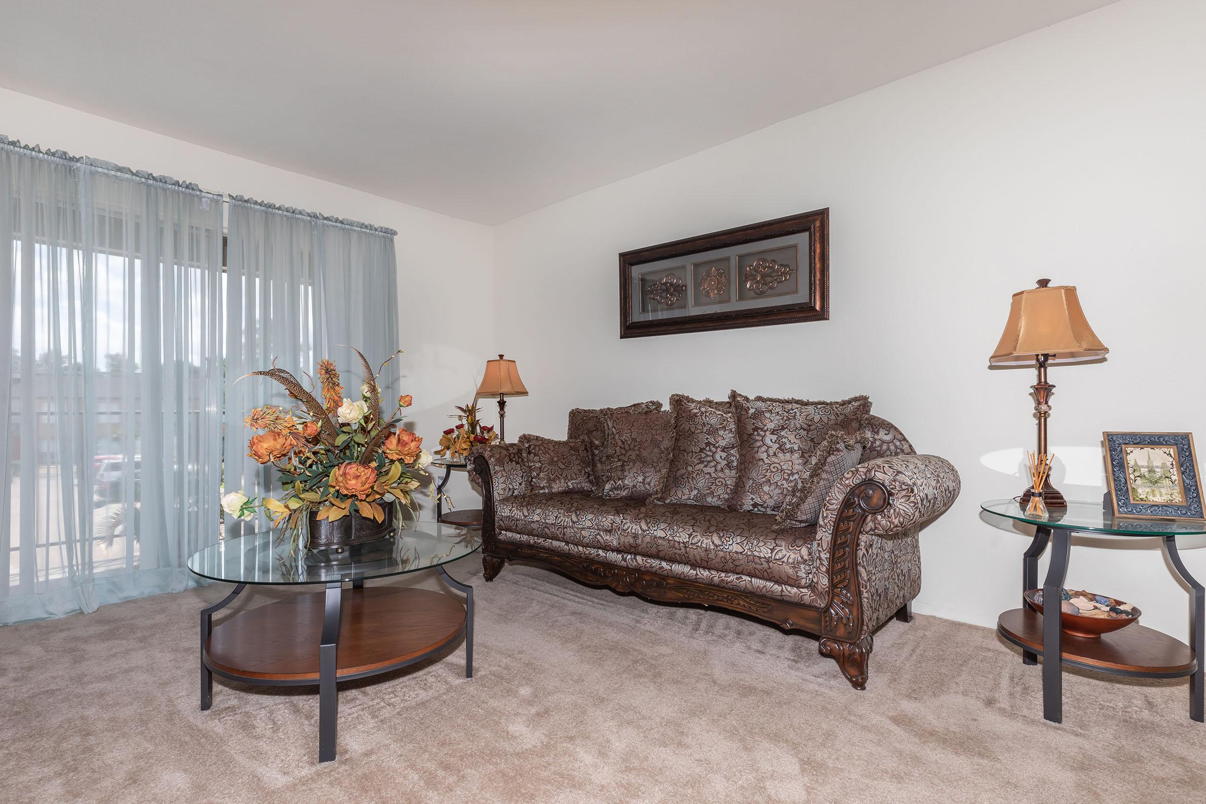 a living room filled with furniture and a lamp