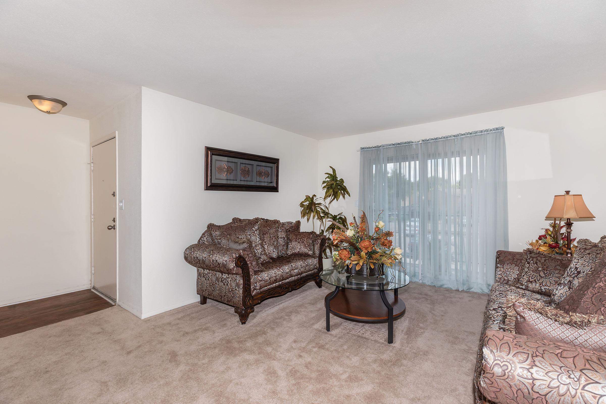 a living room filled with furniture and a tv