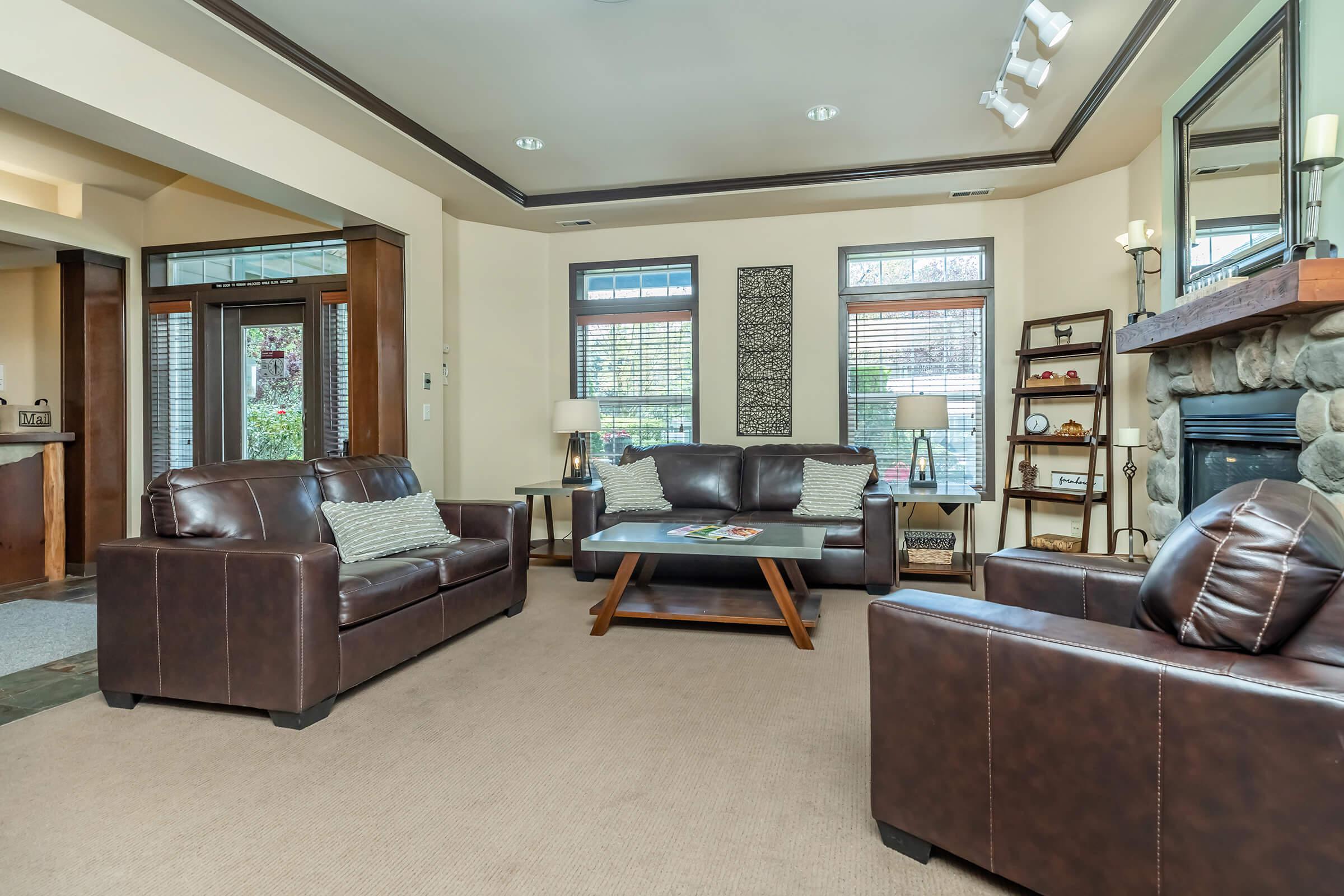 a living room filled with furniture and a large window