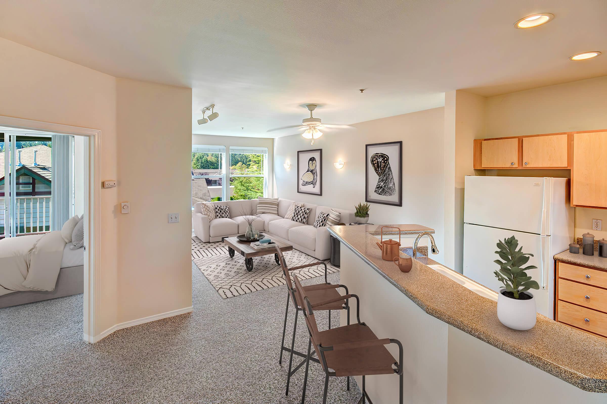 a living room filled with furniture and a large window