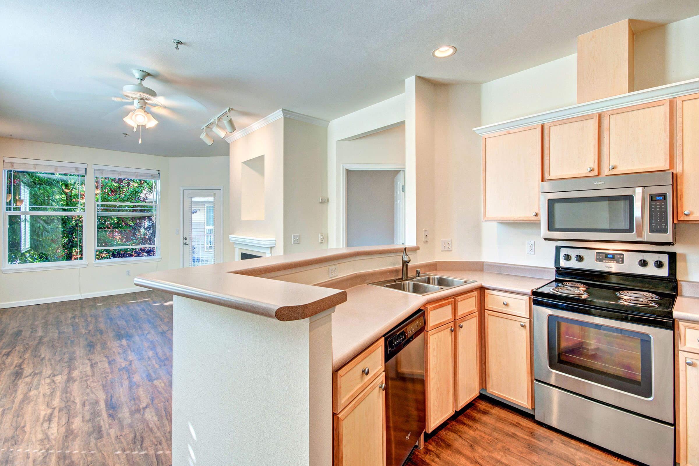 a stove top oven sitting inside of a kitchen