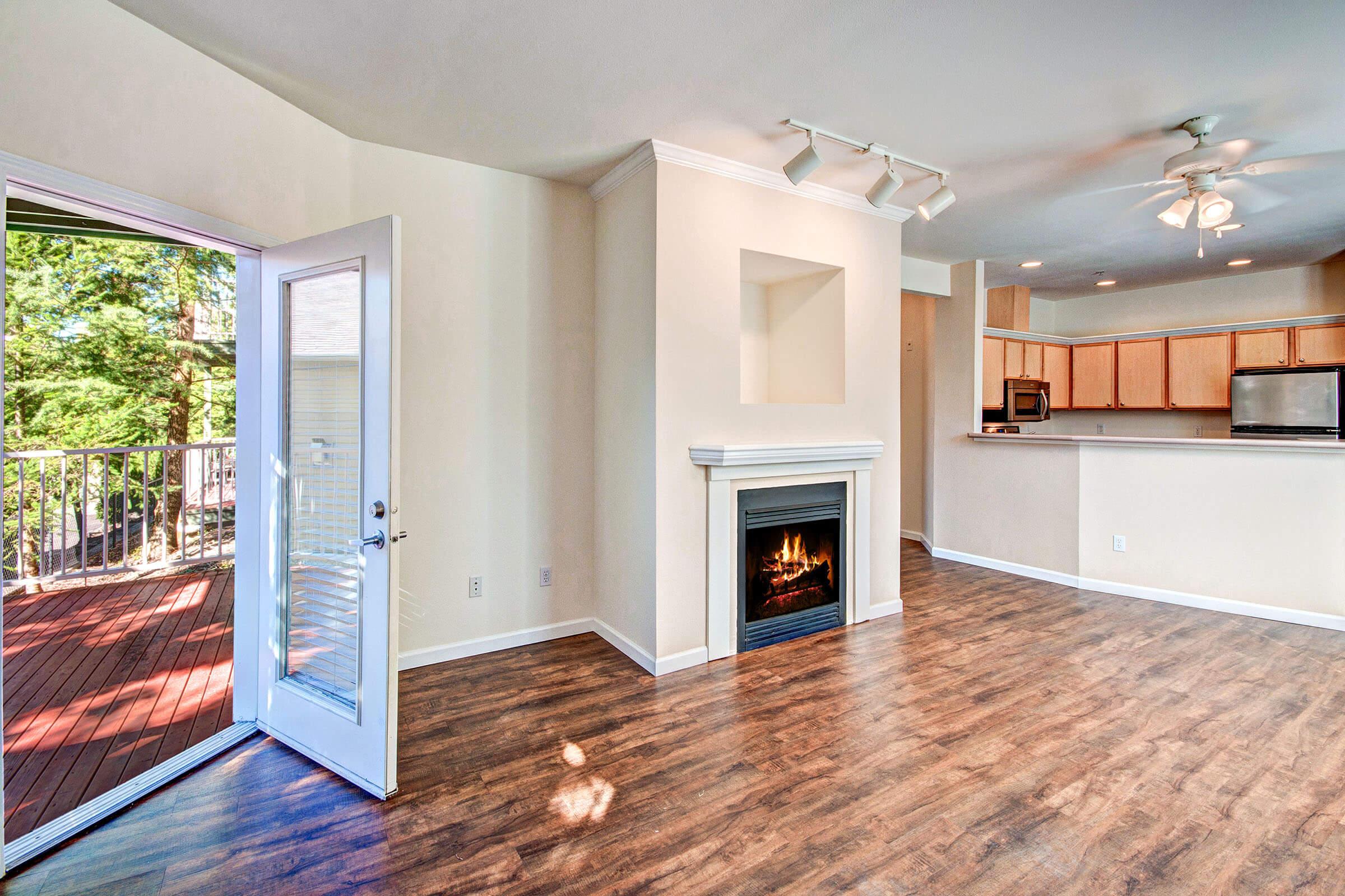 a view of a living room filled with furniture and a fireplace