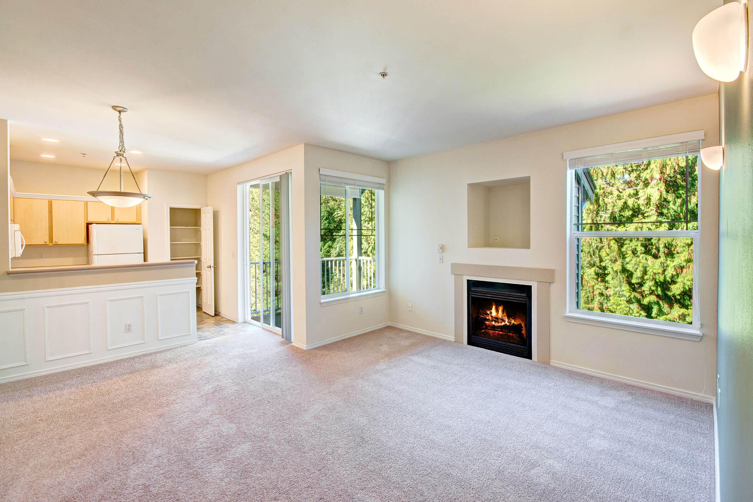 a living room with a fireplace and a large window