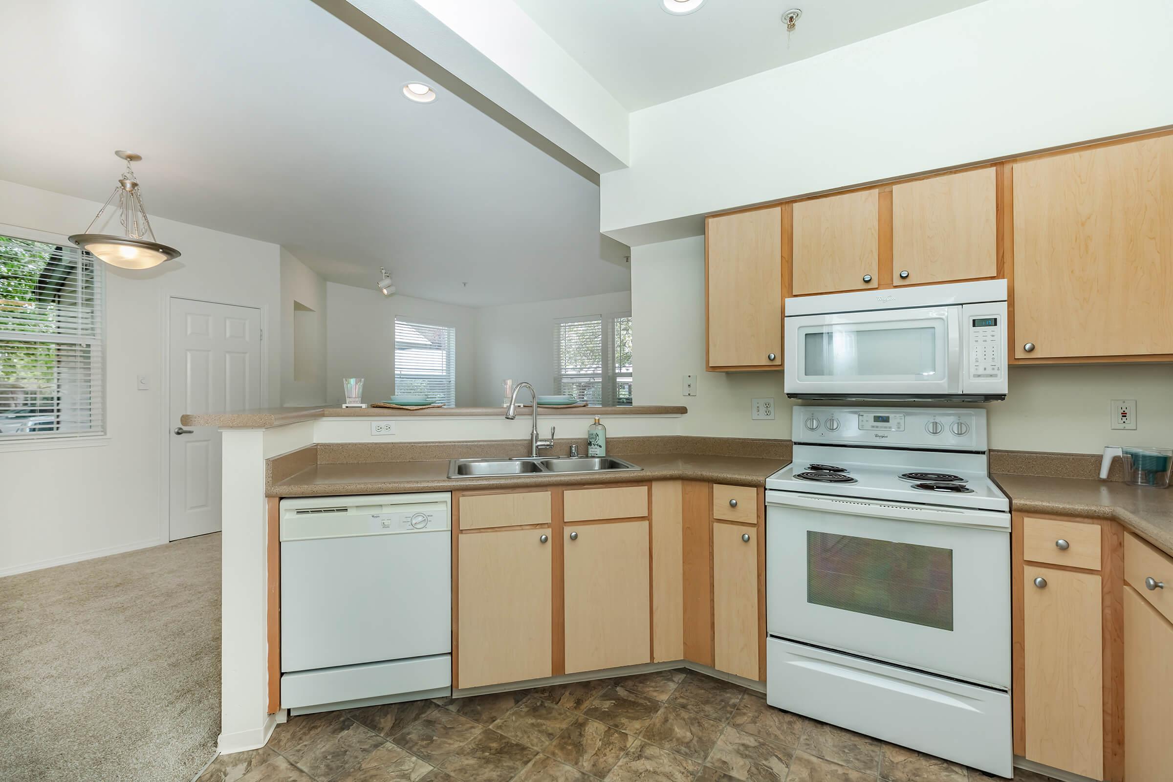 a stove top oven sitting inside of a kitchen