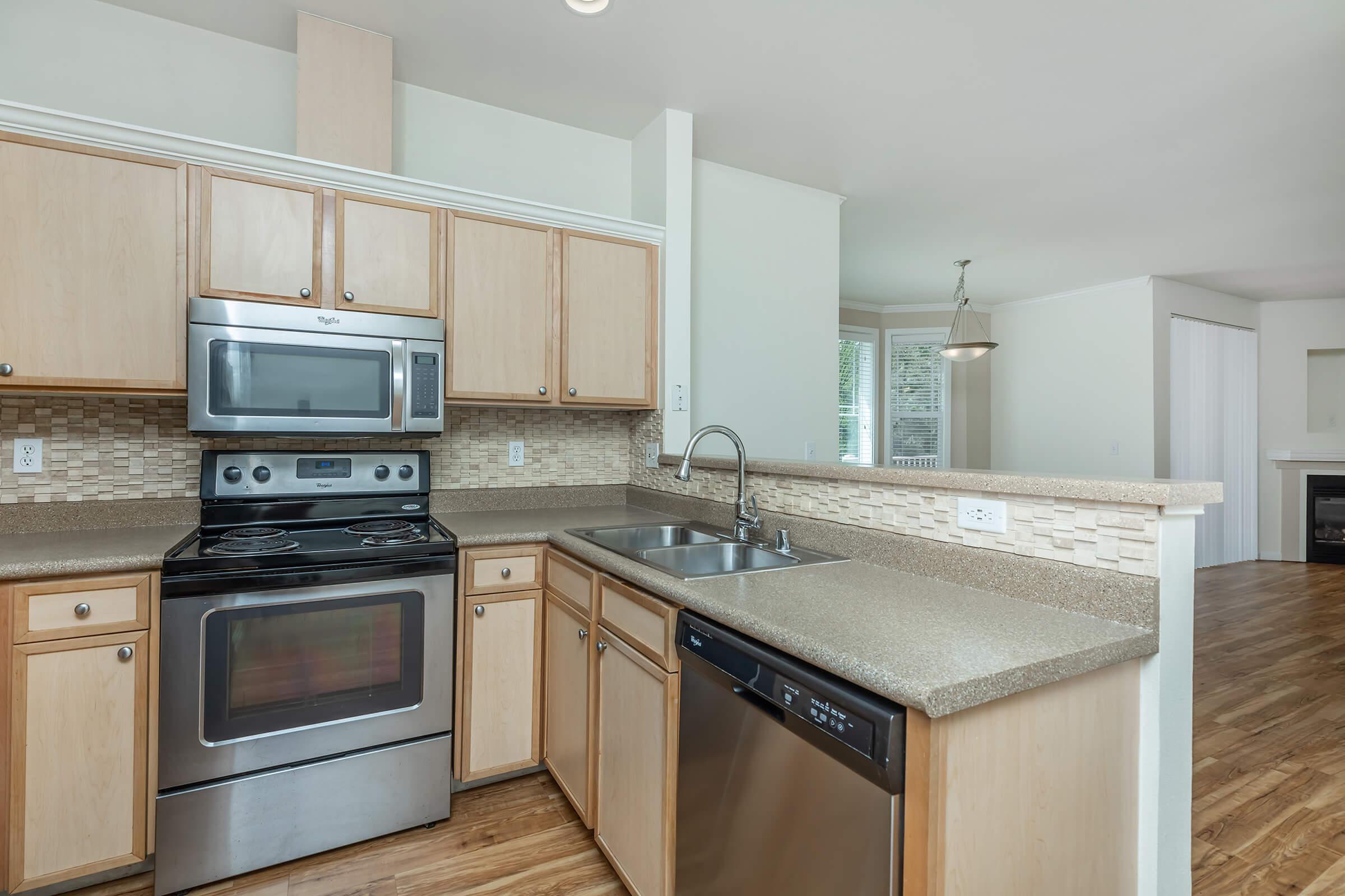 a stove top oven sitting inside of a kitchen