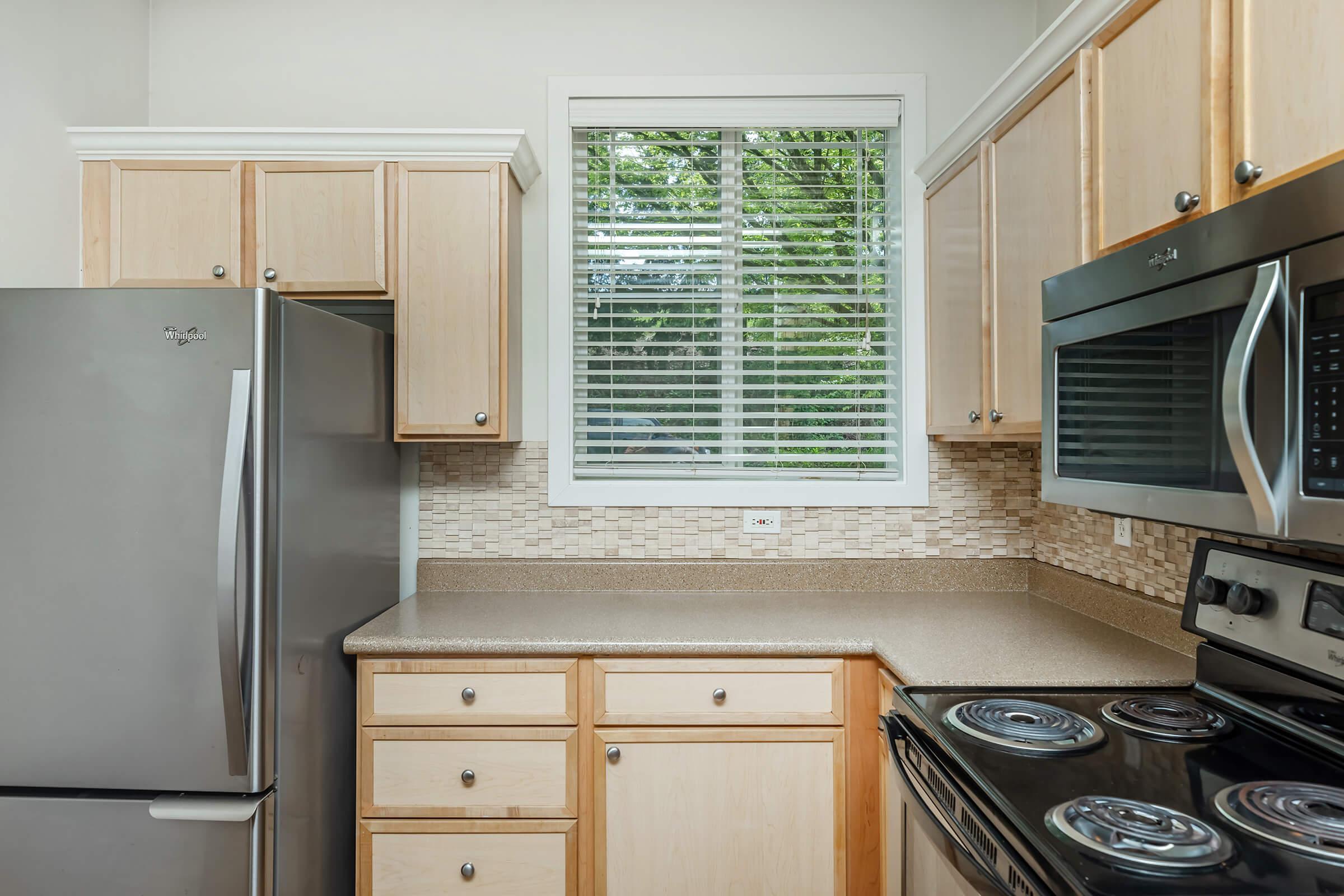 a stove top oven sitting inside of a kitchen