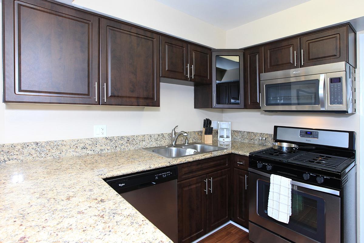 a kitchen with stainless steel appliances and wooden cabinets