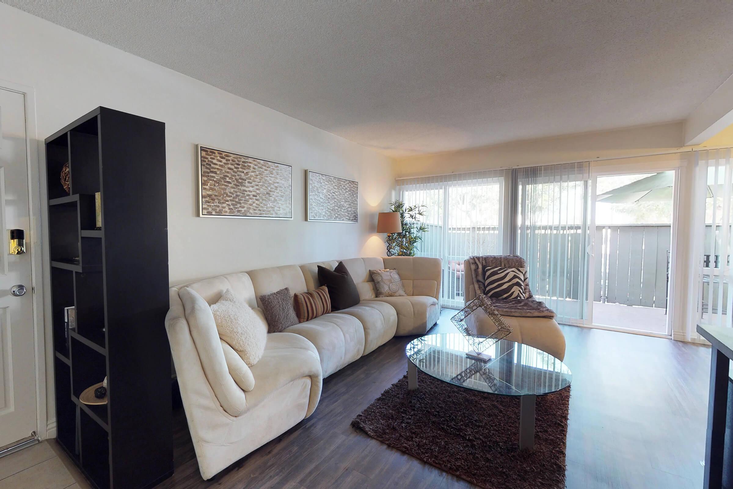 a living room filled with furniture and a large window