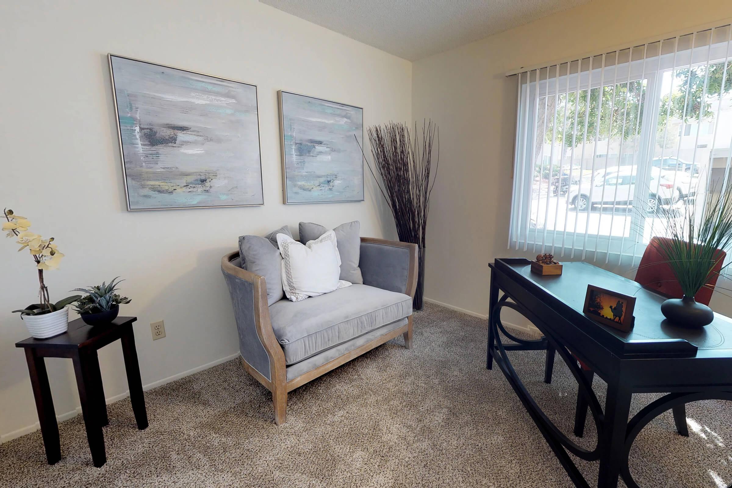 a living room filled with furniture and a large window