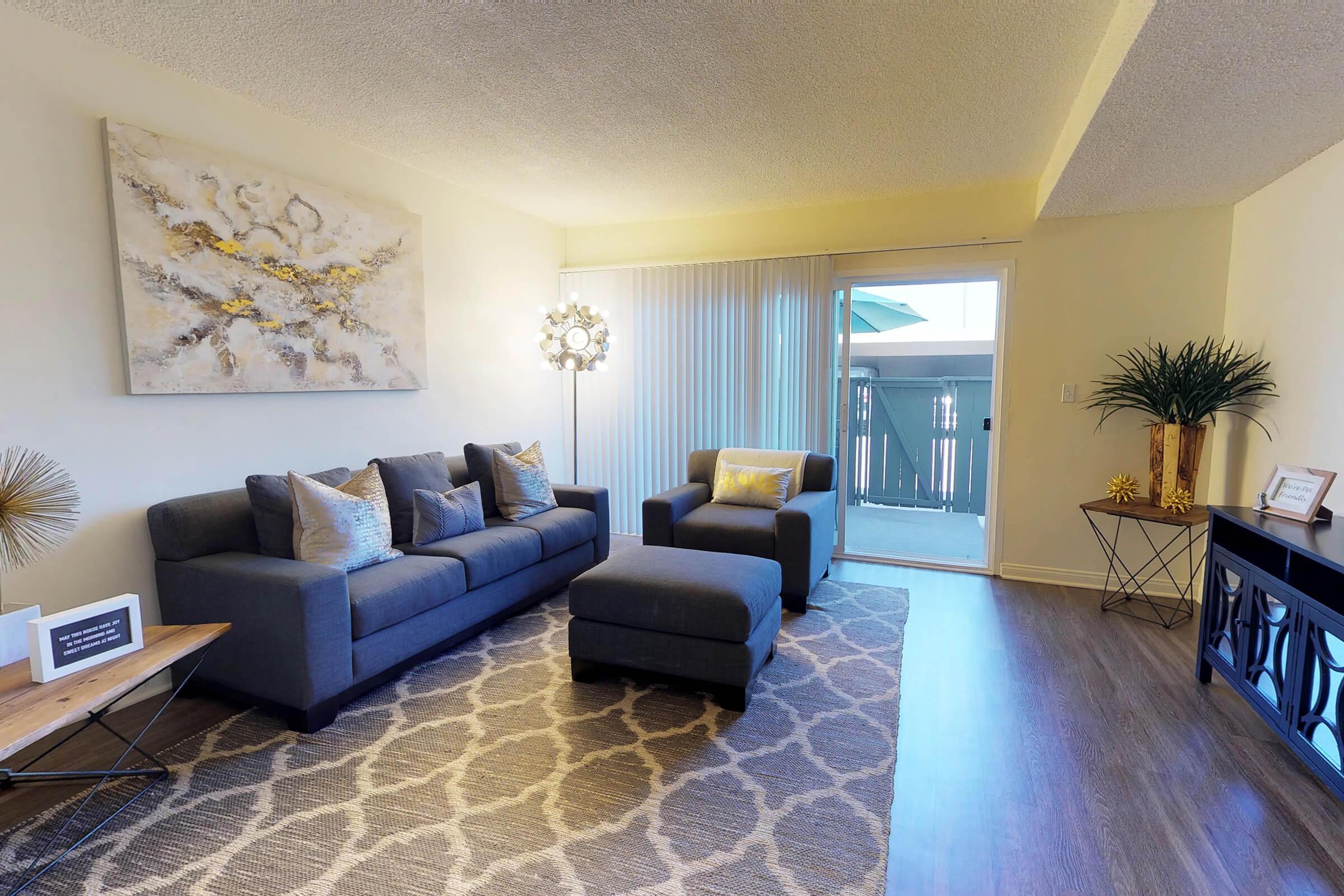 a living room filled with furniture and a rug
