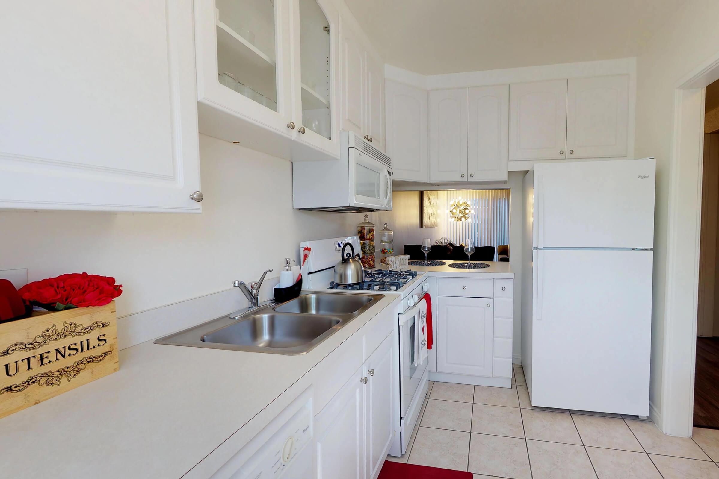 a kitchen with white cabinets