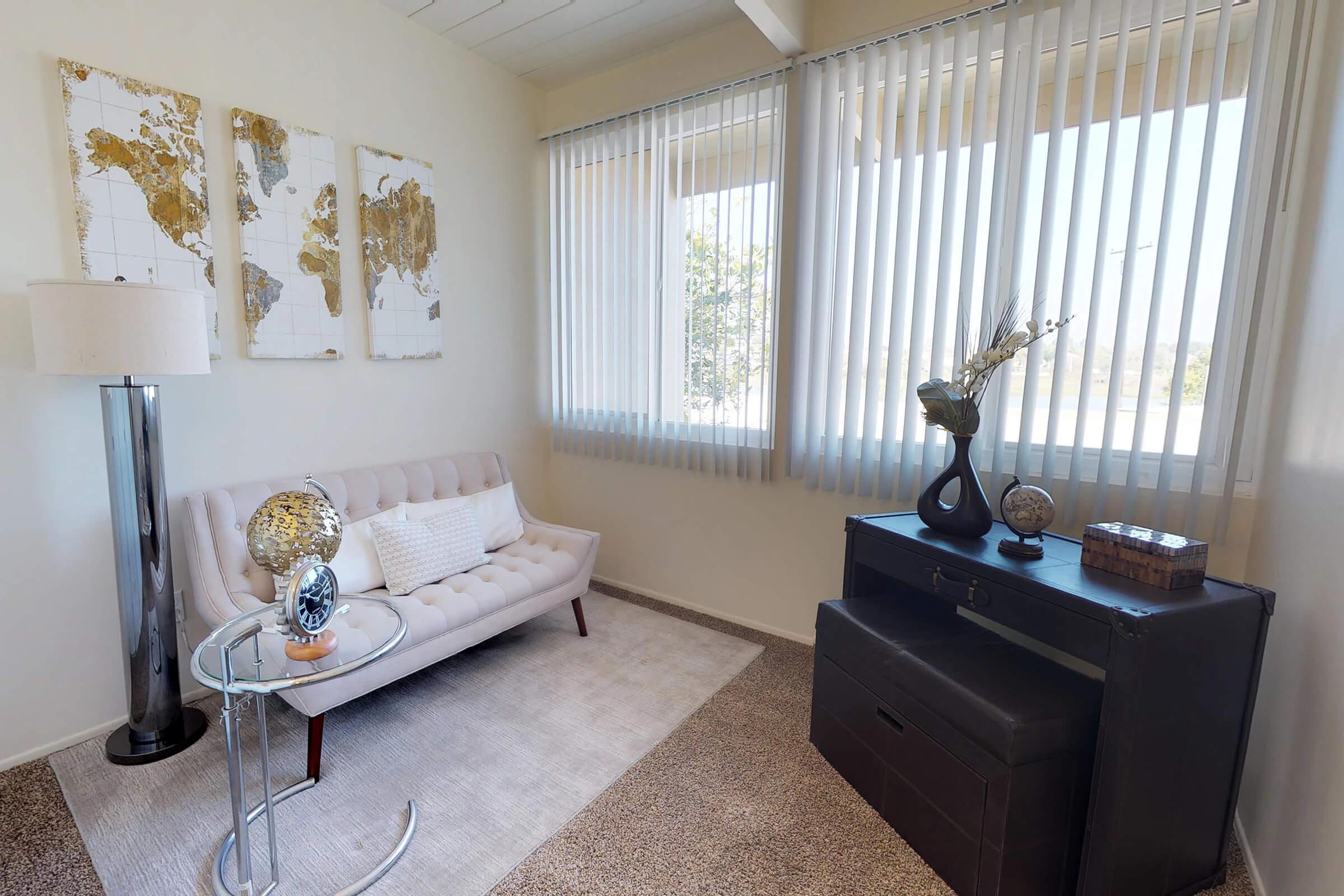 a living room filled with furniture and a large window