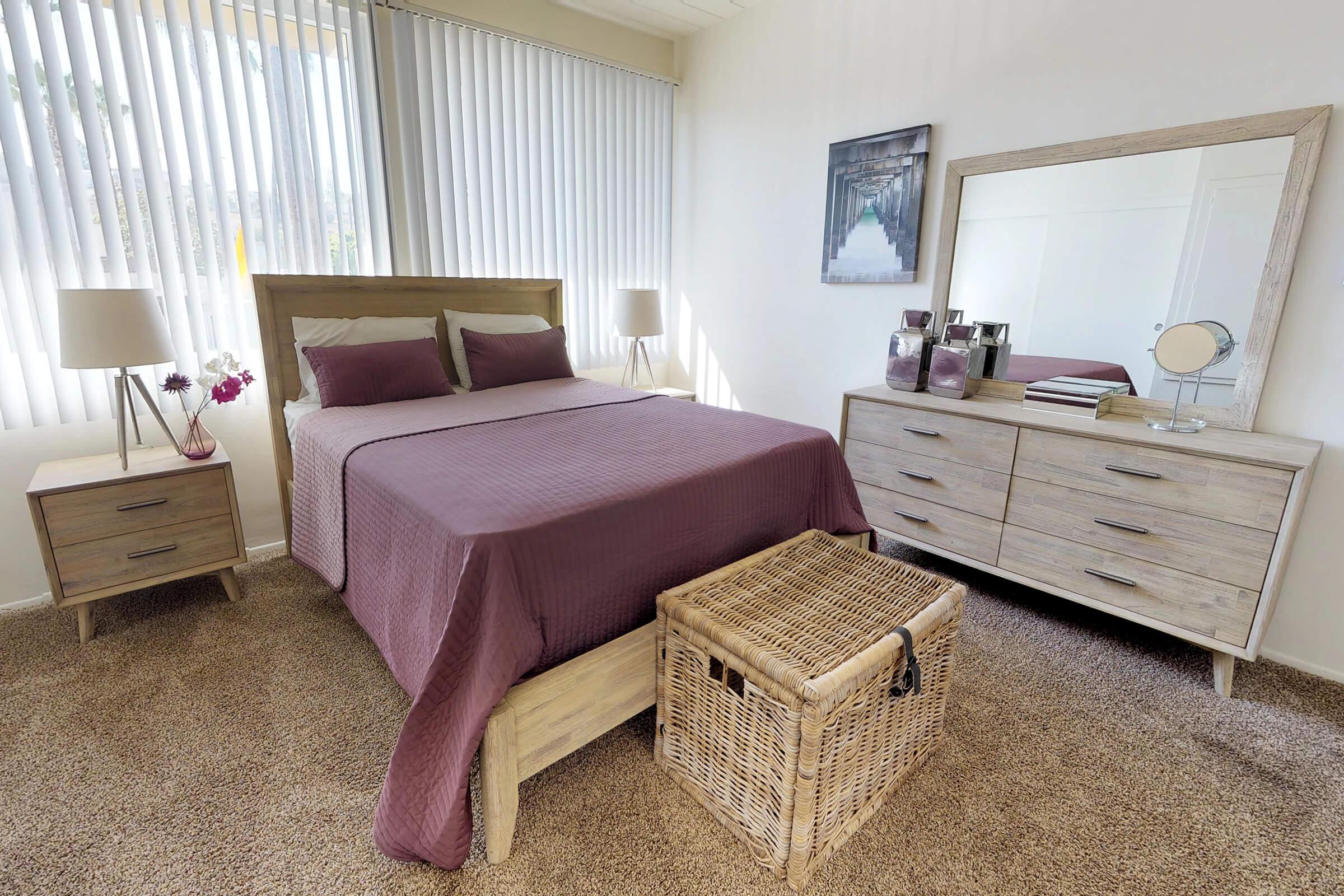 a bedroom with a bed and a chair in a room