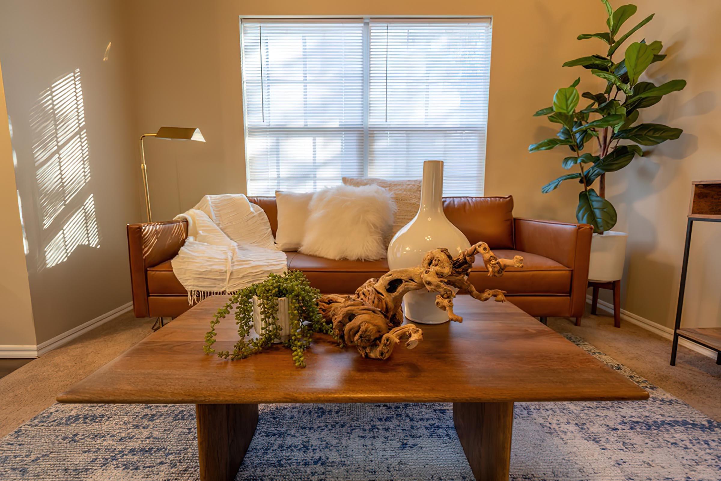 a living room filled with furniture and a large window