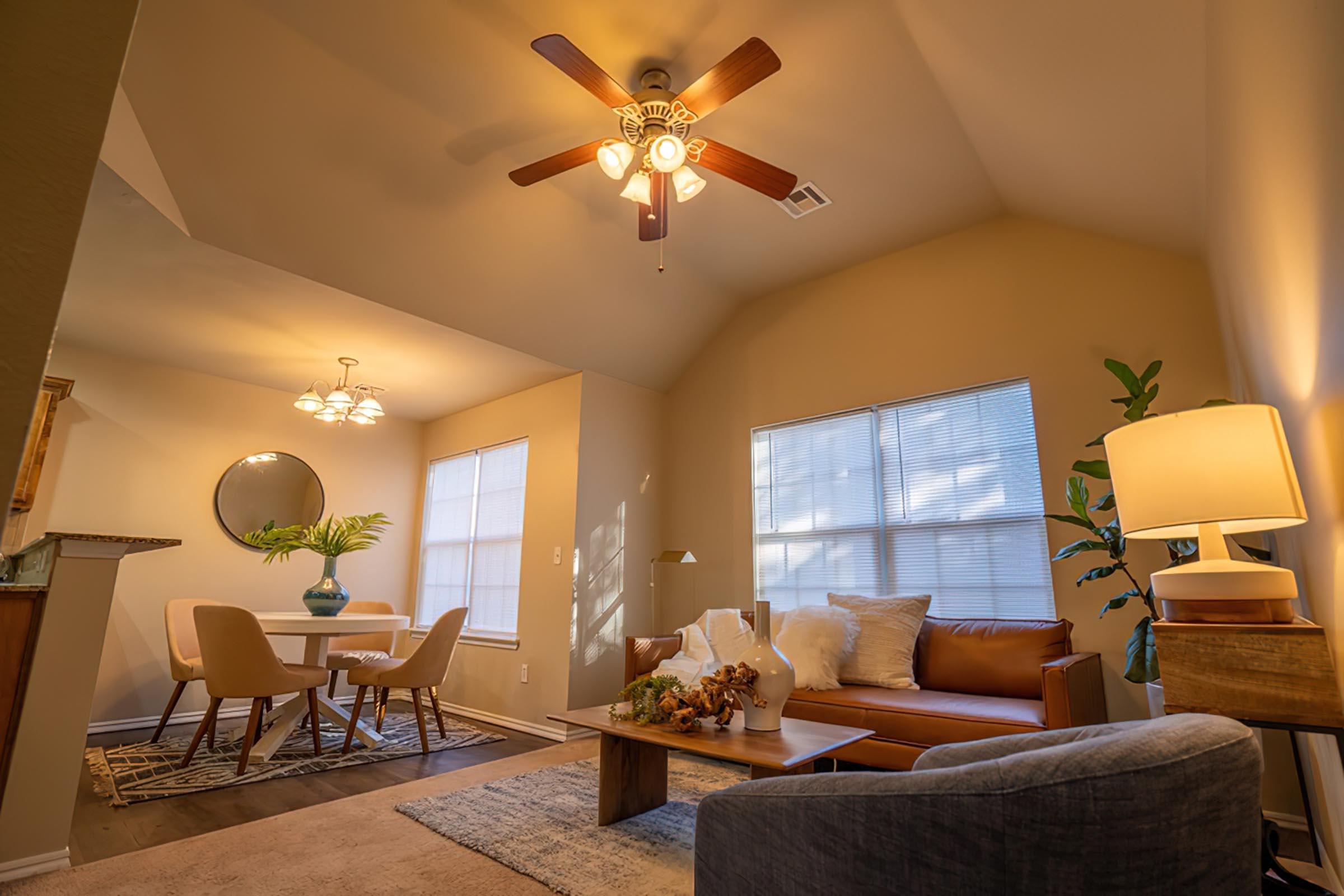 a view of a living room filled with furniture and a fireplace