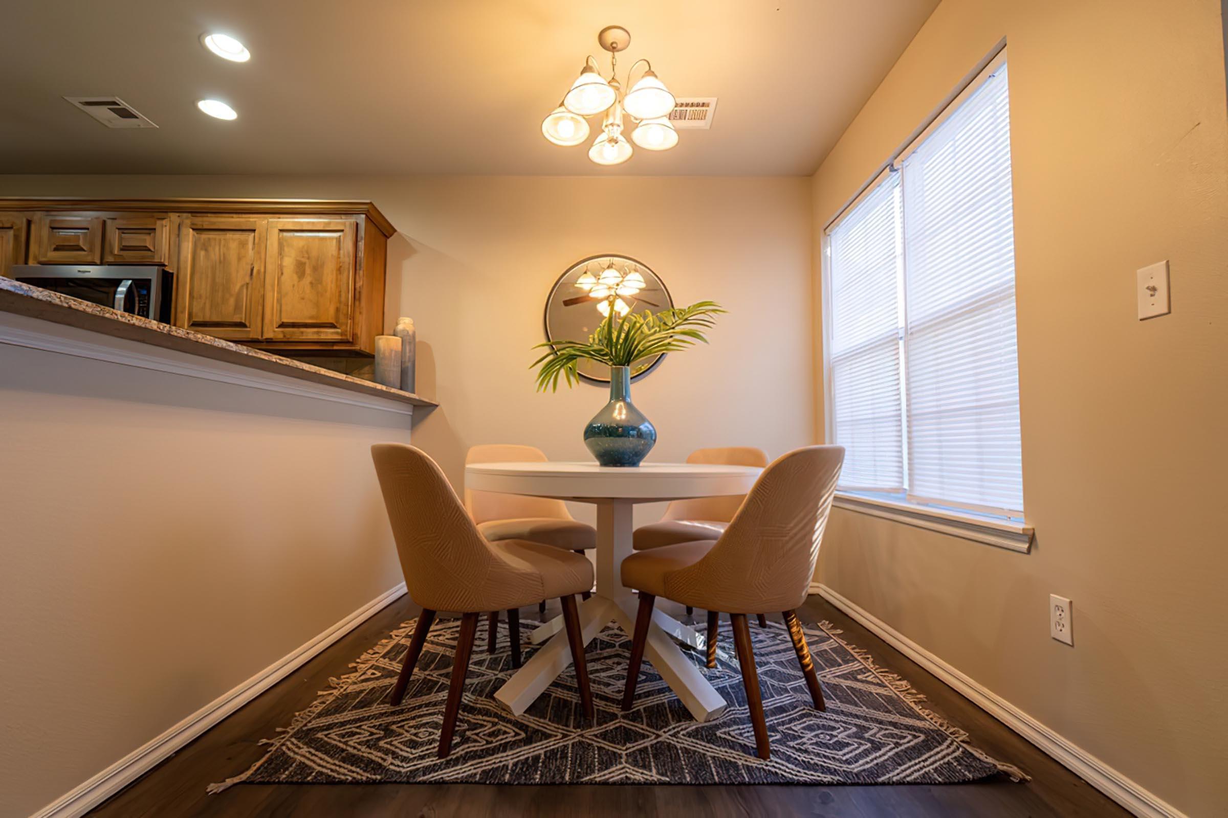 a dining room table in front of a window