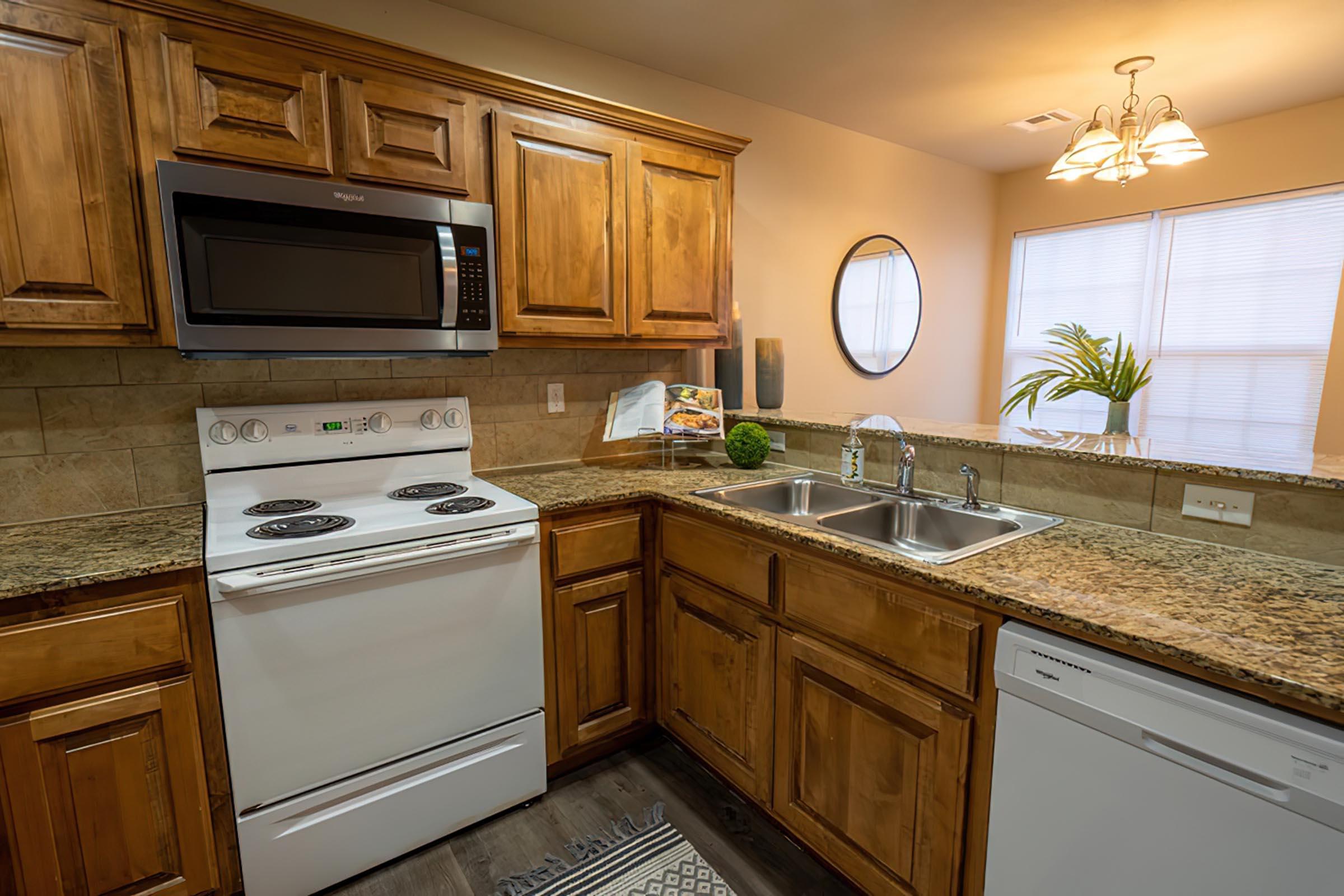 a kitchen with a stove a sink and a microwave