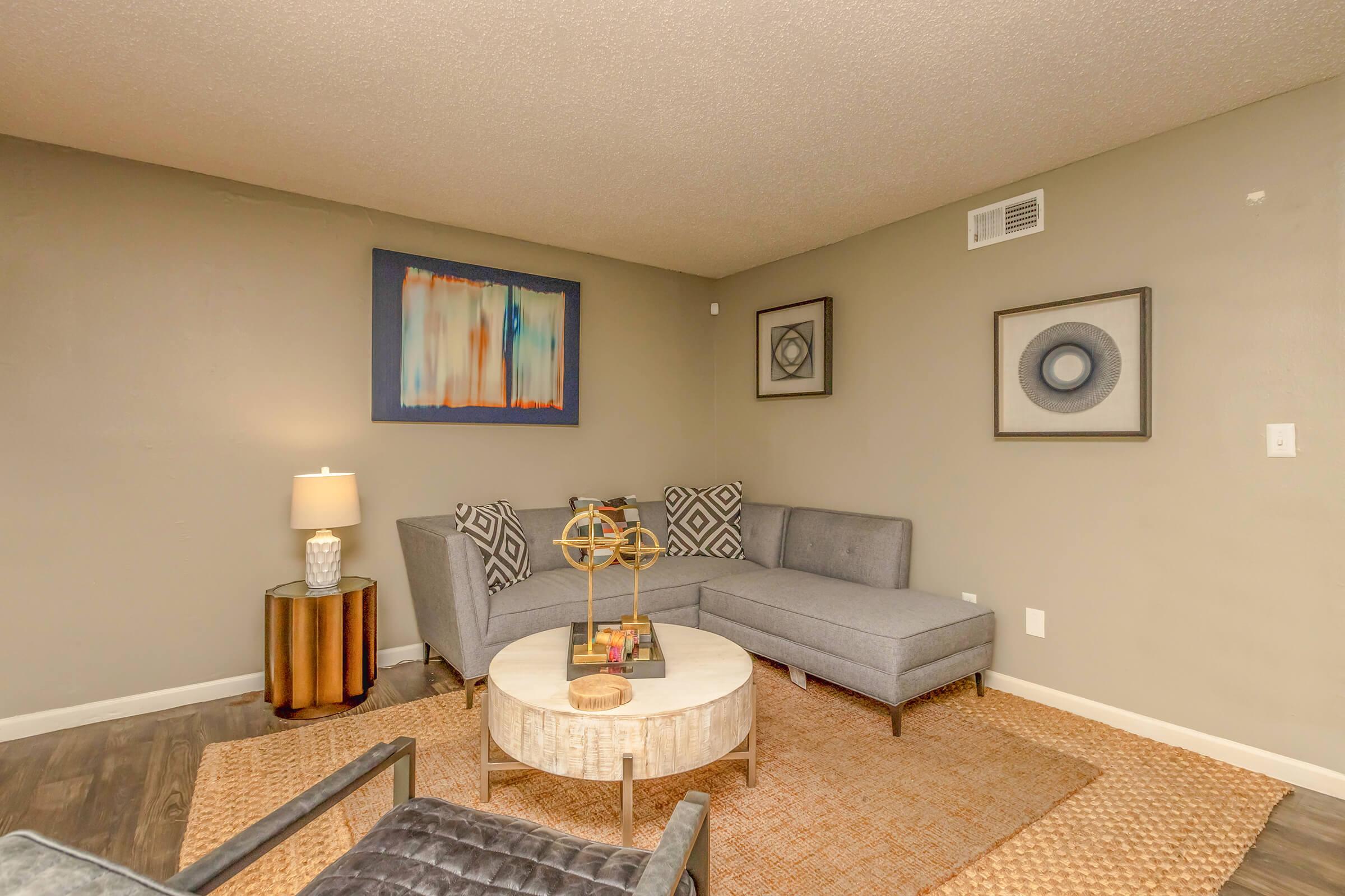 a living room filled with furniture and a flat screen tv