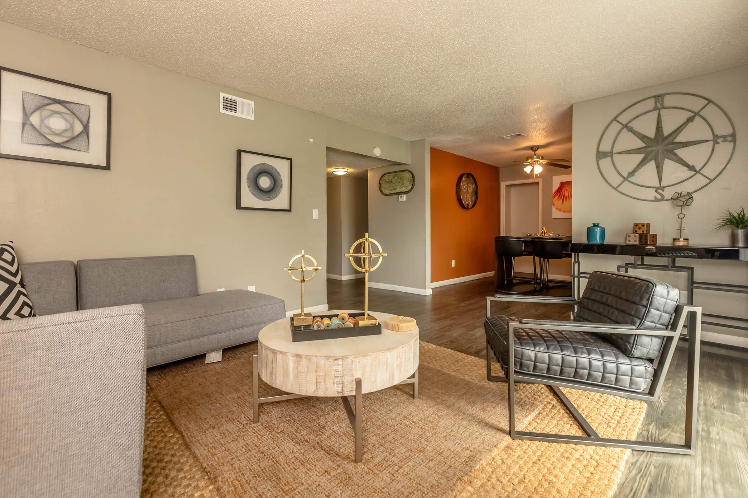 a living room filled with furniture and a mirror